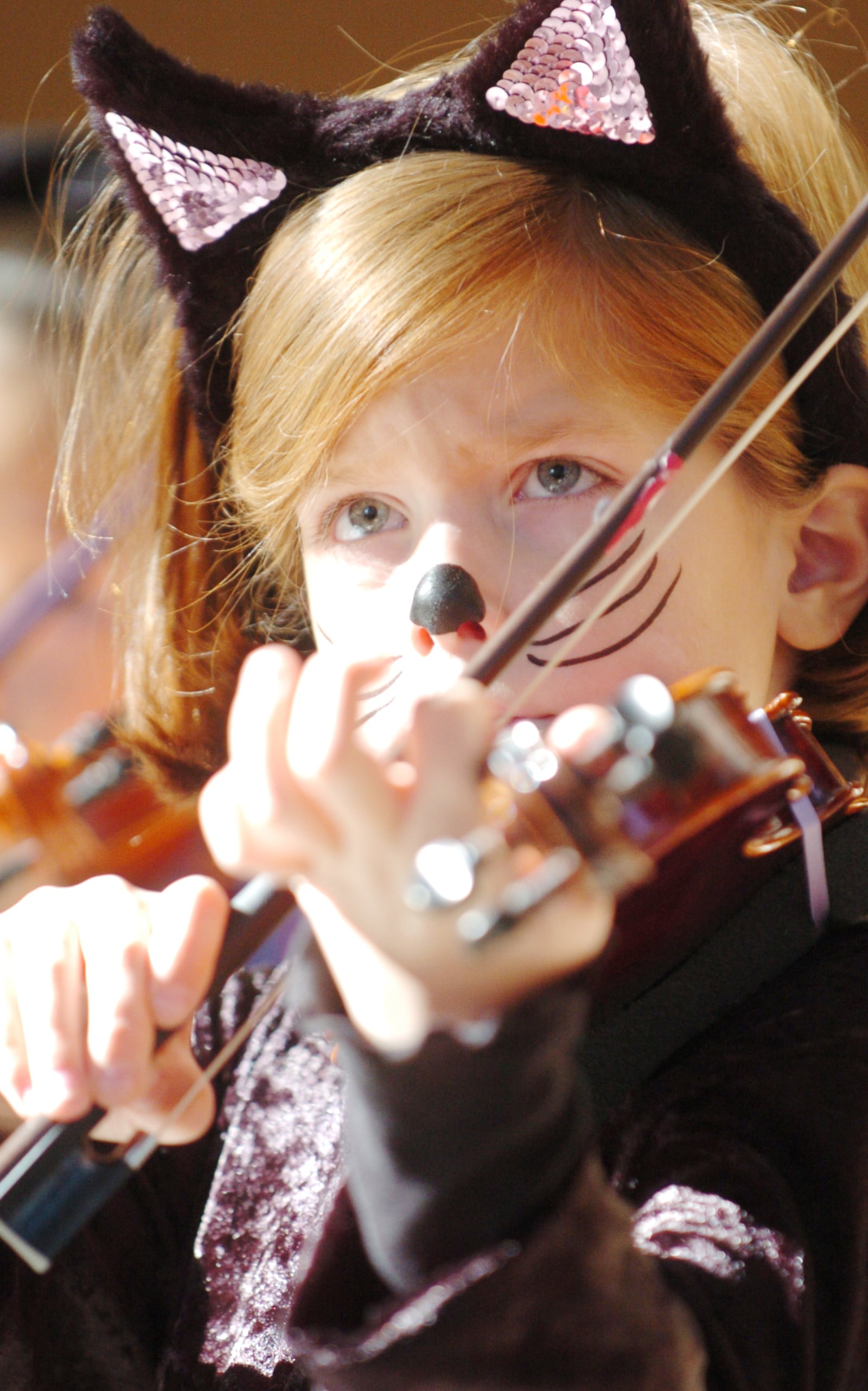 Grace Bradley, 6, of Centerville plays with the Spooky Suzuki Strings before the Dayton Philharmonic Orchestra performed its 14th annual PhilharMonster Halloween Concert on Sunday, Oct. 28, 2007 at the Schuster Center in Dayton, Ohio.