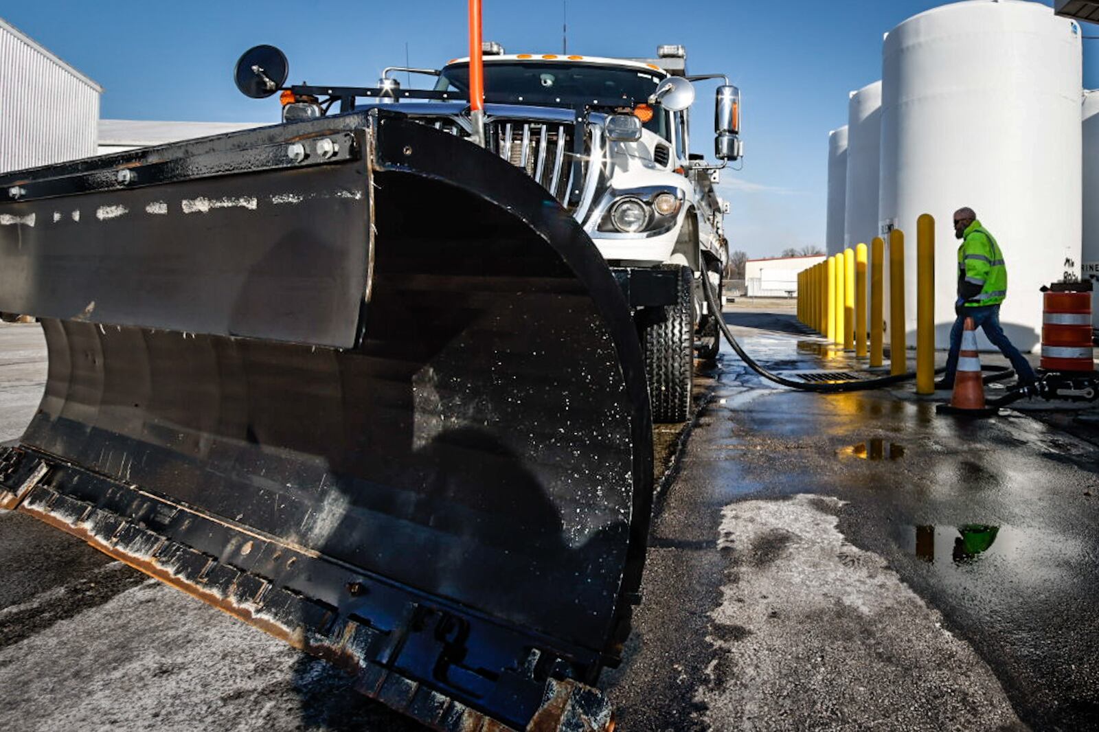 Ohio Department of Transportation snowplow driver, Rob Gardner pumps an 80/20 brine mixture into his truck Tuesday, Dec. 20, 2022. ODOT road crews are readying their equipment for the winter weather heading to the Dayton area ahead of the holiday weekend. JIM NOELKER/STAFF