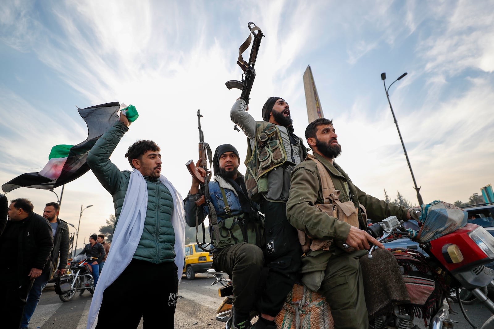 FILE - Syrian opposition fighters celebrate after the Syrian government collapsed in Damascus, Syria, on Sunday, Dec. 8, 2024. (AP Photo/Omar Sanadiki, File)