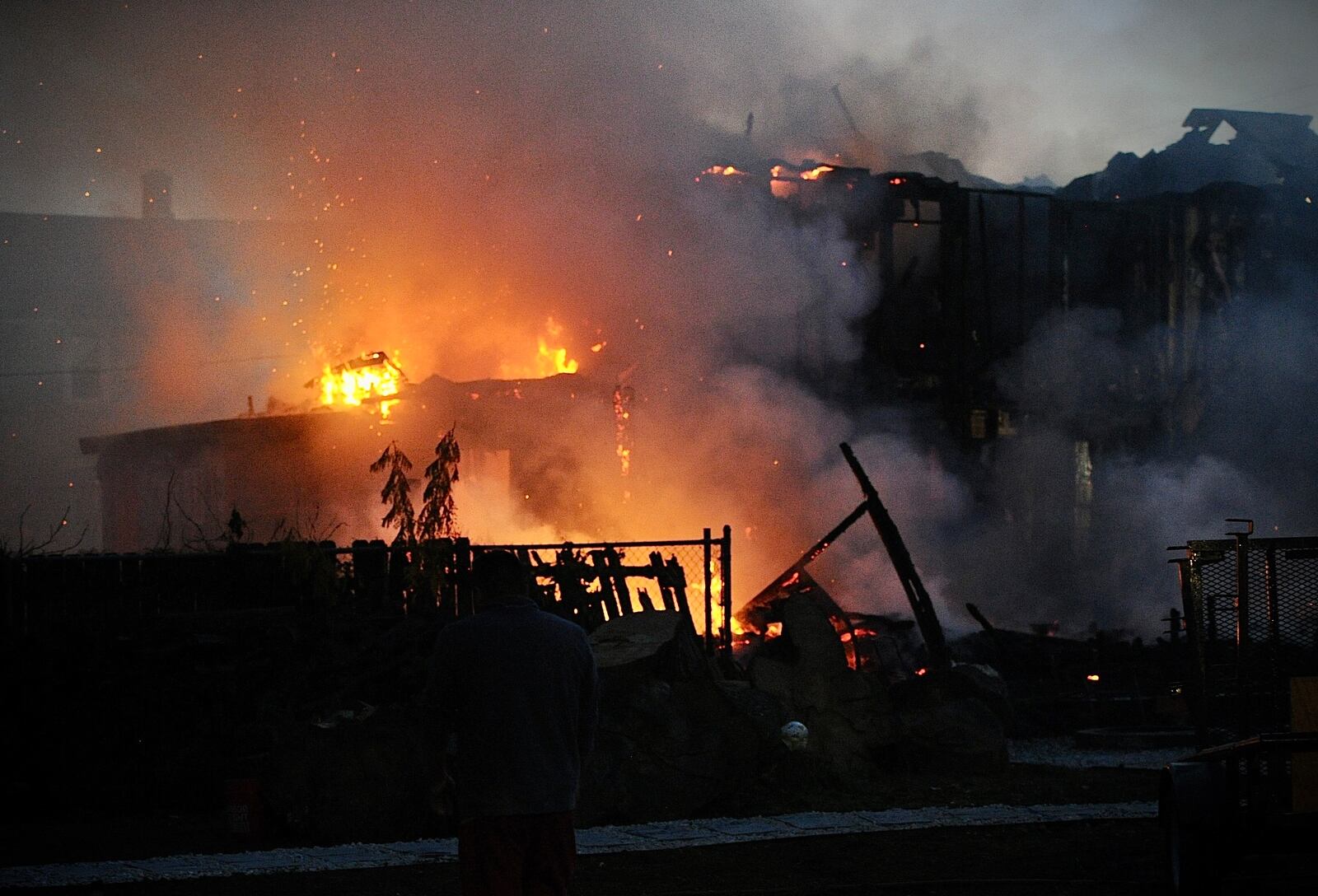 Fire destroyed a vacant house, the house next door and damaged a third house Monday evening, Nov. 7, 2022, in the 200 block of Alaska Street in Dayton. MARSHALL GORBY/STAFF