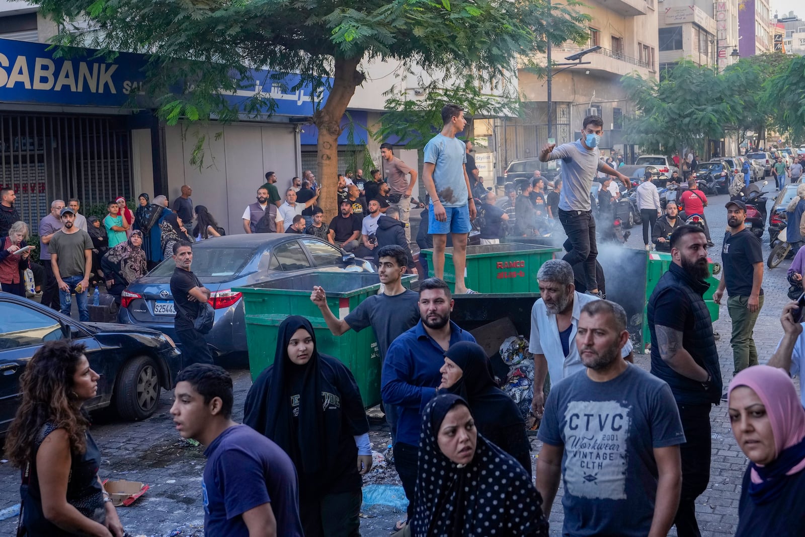 People displaced by Israel's war on Hezbollah gesture after scuffle with members of the Lebanese security, after dozens of policemen arrived at the building to evict the displaced from the private property, in Beirut, Lebanon, Monday, Oct. 21, 2024. (AP Photo/Hassan Ammar)