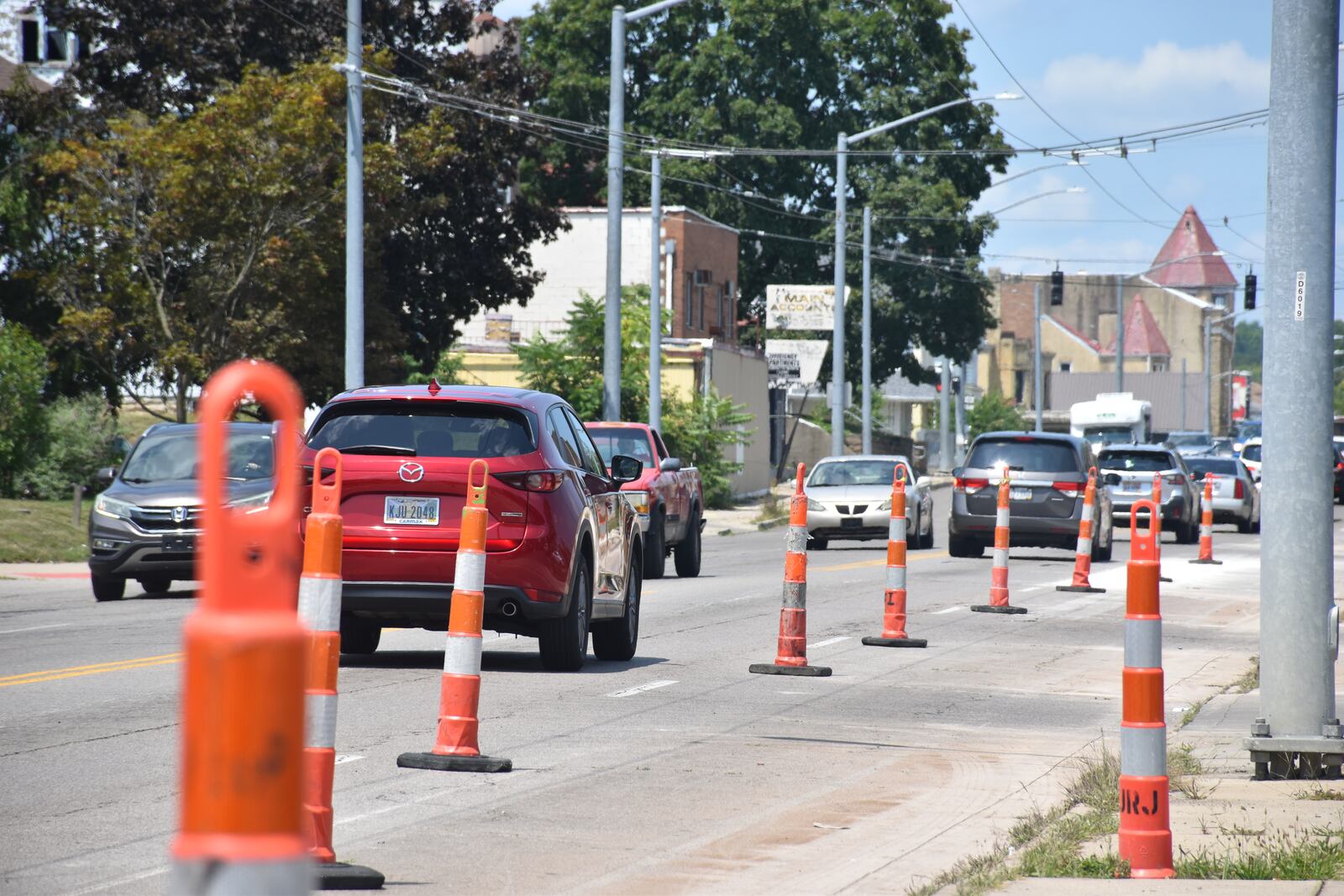 Traffic cones block off the curb lane on the northbound side of North Main Street, between Great Miami Boulevard and Burton Avenue. North Main Street is being put on a road diet. CORNELIUS FROLIK / STAFF