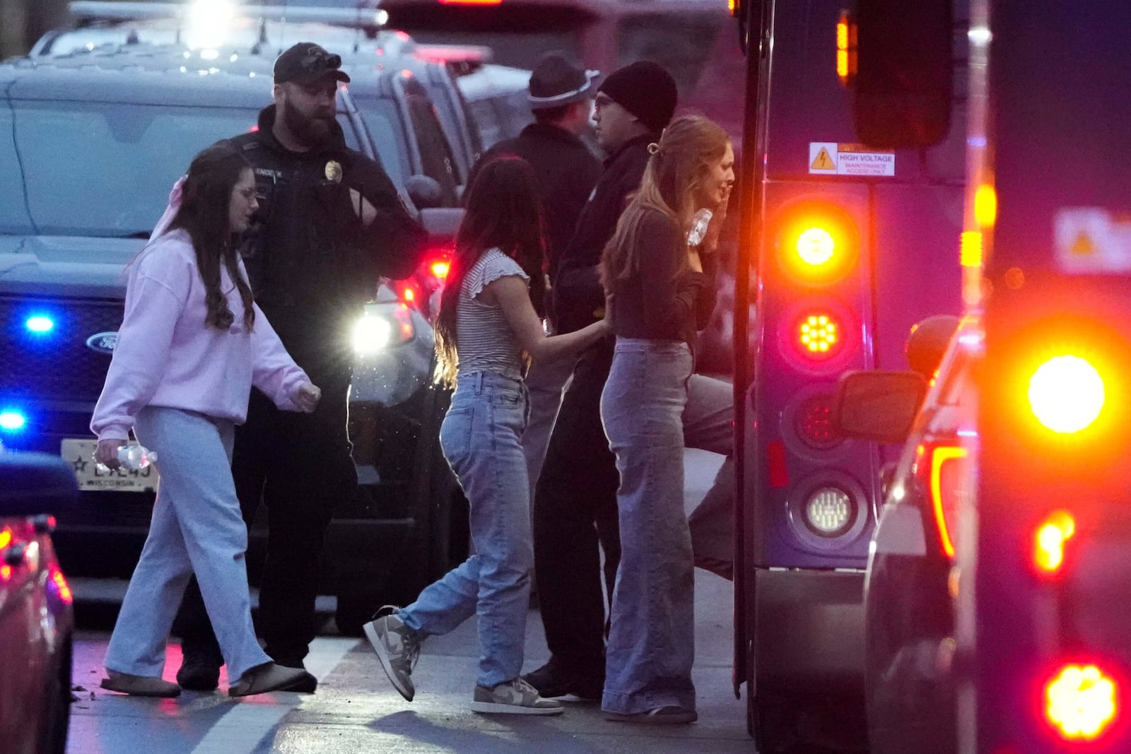 Students aboard a bus as they leave the shelter following a shooting at the Abundant Life Christian School, Monday, Dec. 16, 2024. (AP Photo/Morry Gash)