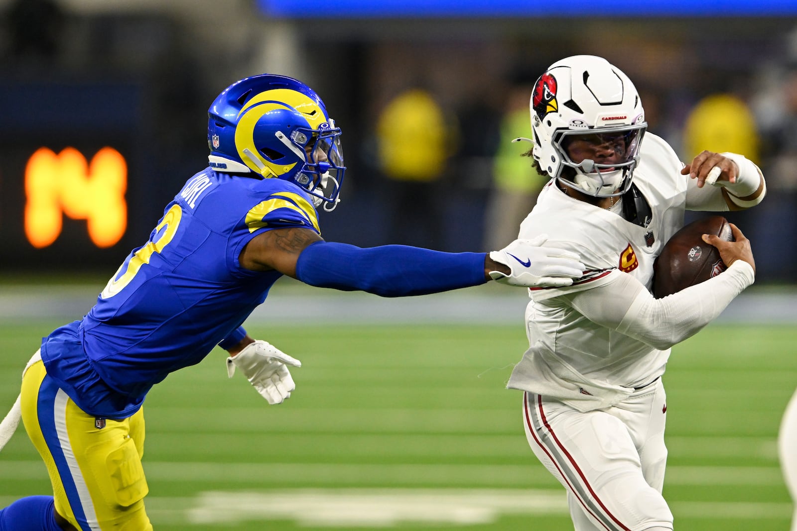 Arizona Cardinals quarterback Kyler Murray (1) runs past Los Angeles Rams safety Kamren Curl (3) during the first half of an NFL football game Saturday, Dec. 28, 2024, in Inglewood, Calif. (AP Photo/Alex Gallardo)