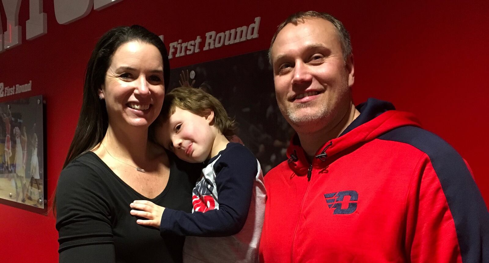 Dayton women’s basketball coach Shauna Green, her husband Andy and their son Matteo at UD Arena. DAVID JABLONSKI / STAFF