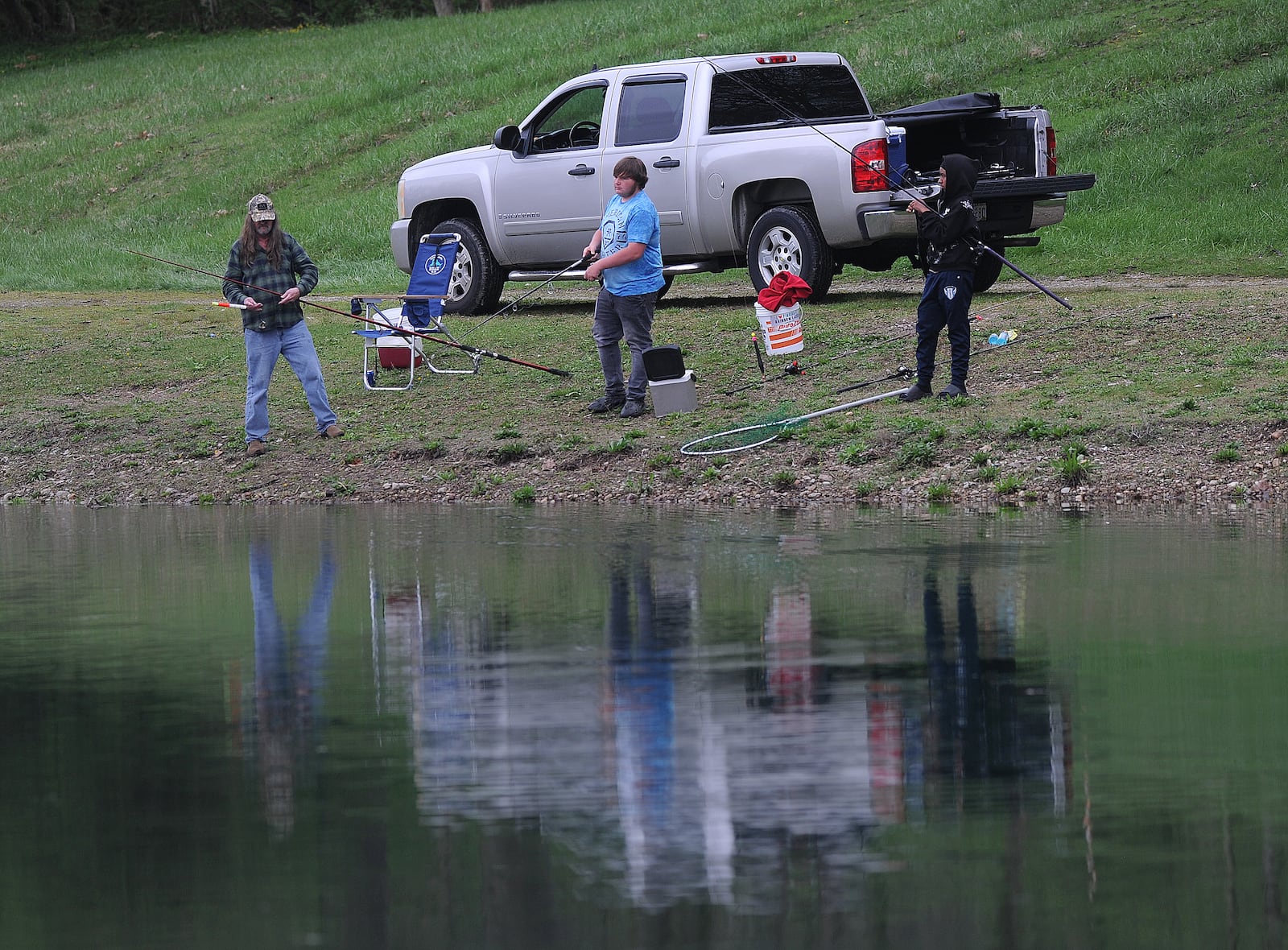 People come to Rainbow Lakes in Fairborn to relax and fish on Wednesday, April 10, 2024. MARSHALL GORBY\STAFF