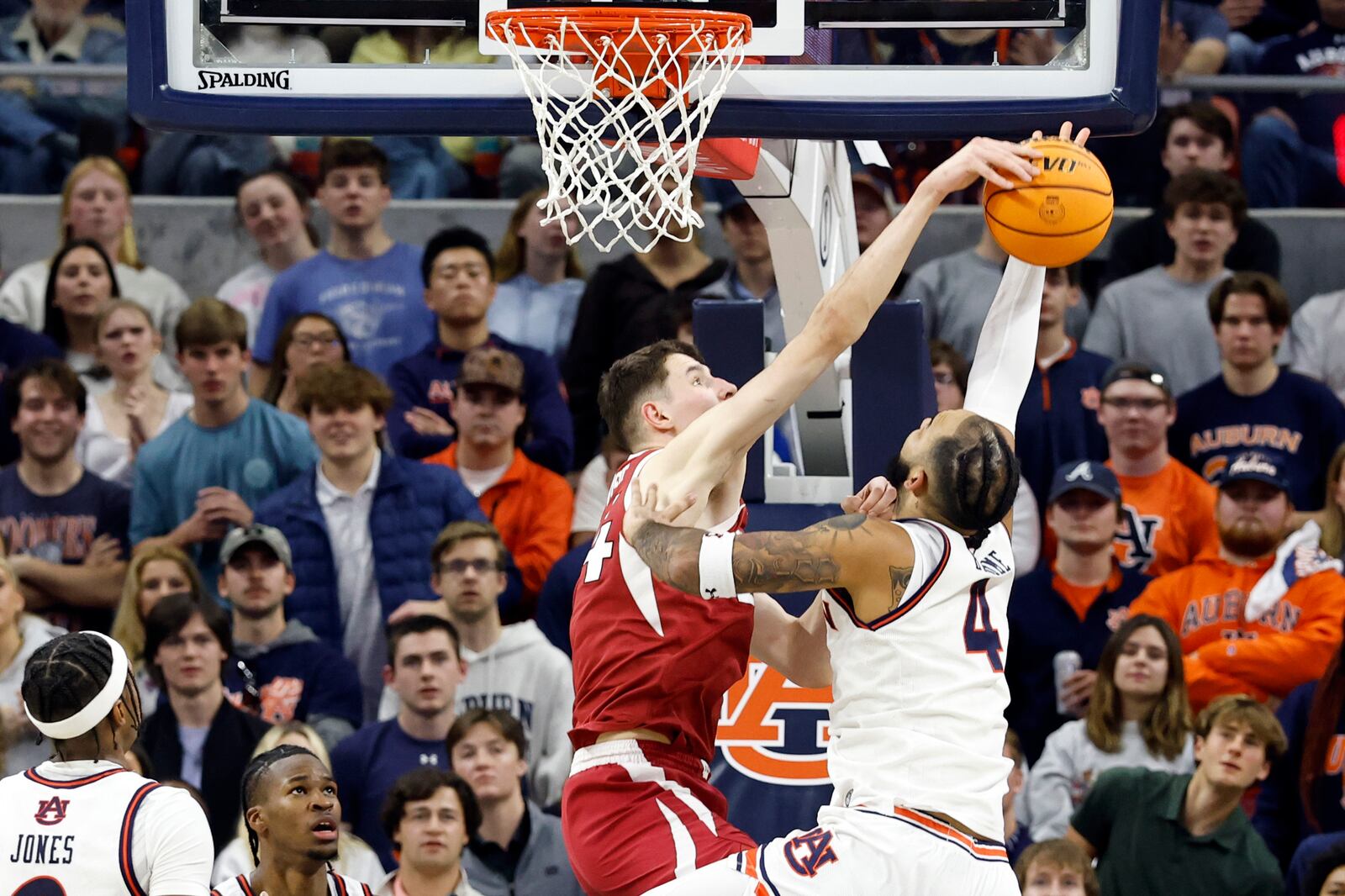 Arkansas forward Zvonimir Ivisic (44) blocks the shot attempt of Auburn forward Johni Broome (4) during the first half of an NCAA college basketball game, Wednesday, Feb. 19, 2025, in Auburn, Ala. (AP Photo/Butch Dill)