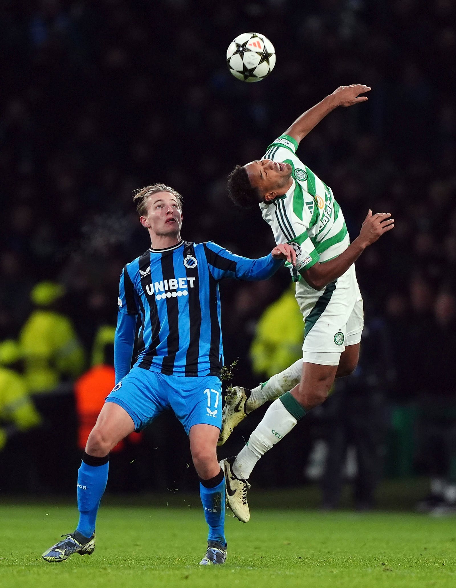 Celtic's Auston Trusty and Club Brugge's Romeo Vermant, left, in action during the UEFA Champions League opening phase soccer stage match at Celtic Park, Glasgow, Scotland, Wednesday Nov. 27, 2024. (Andrew Milligan/PA via AP)