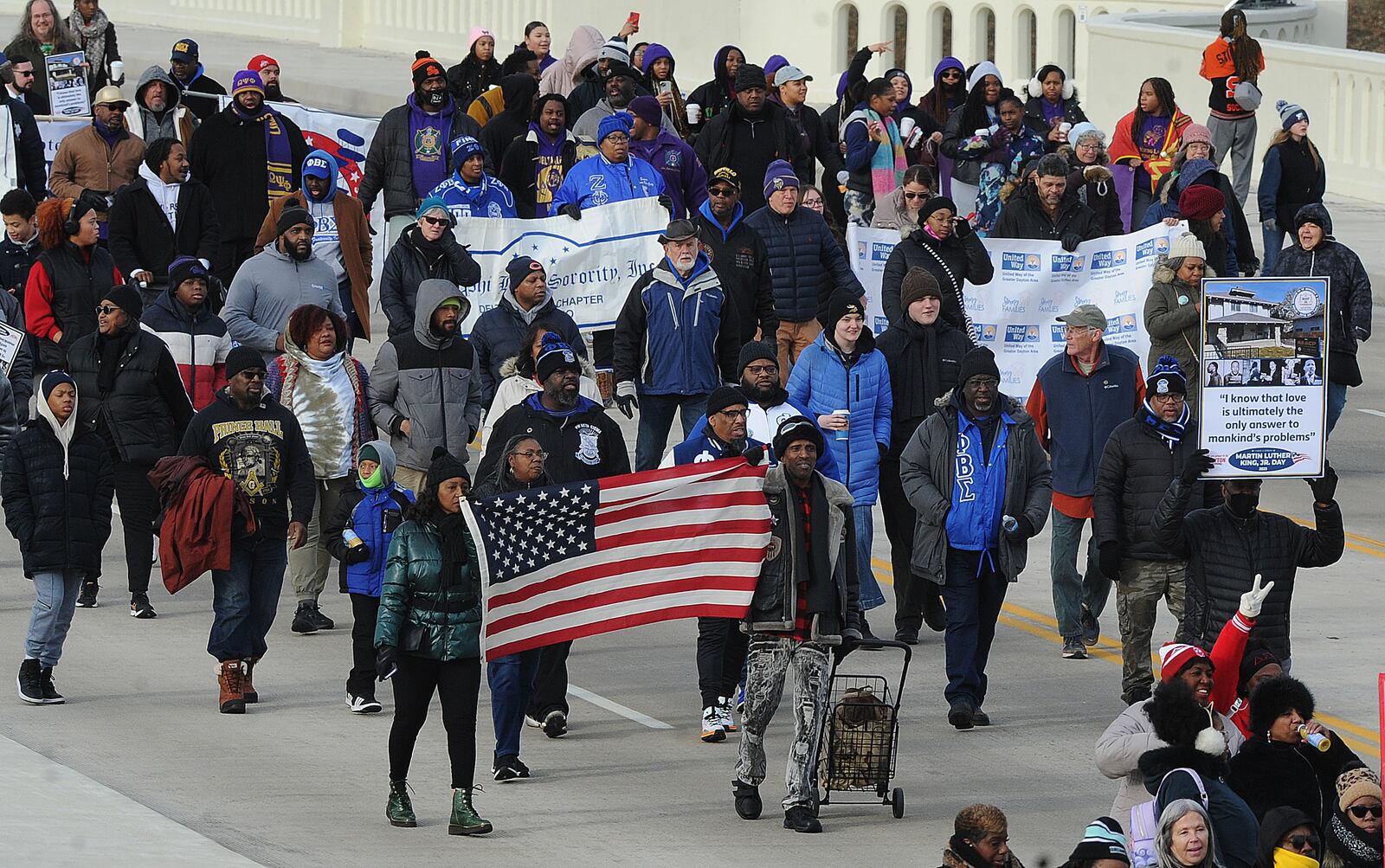 The MLK Memorial March travels over the Third Street bridge into downtown Monday Jan. 16, 2023. MARSHALL GORBY\STAFF