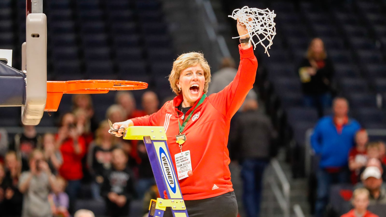 Cutline: Fort Loramie High School girls basketball coach Carla Siegel celebrates after cutting down the net on Saturday, March 16 at University of Dayton Arena. The Redskins beat Waterford 42-29 to win the Division IV state championship. Michael Cooper/CONTRIBUTED