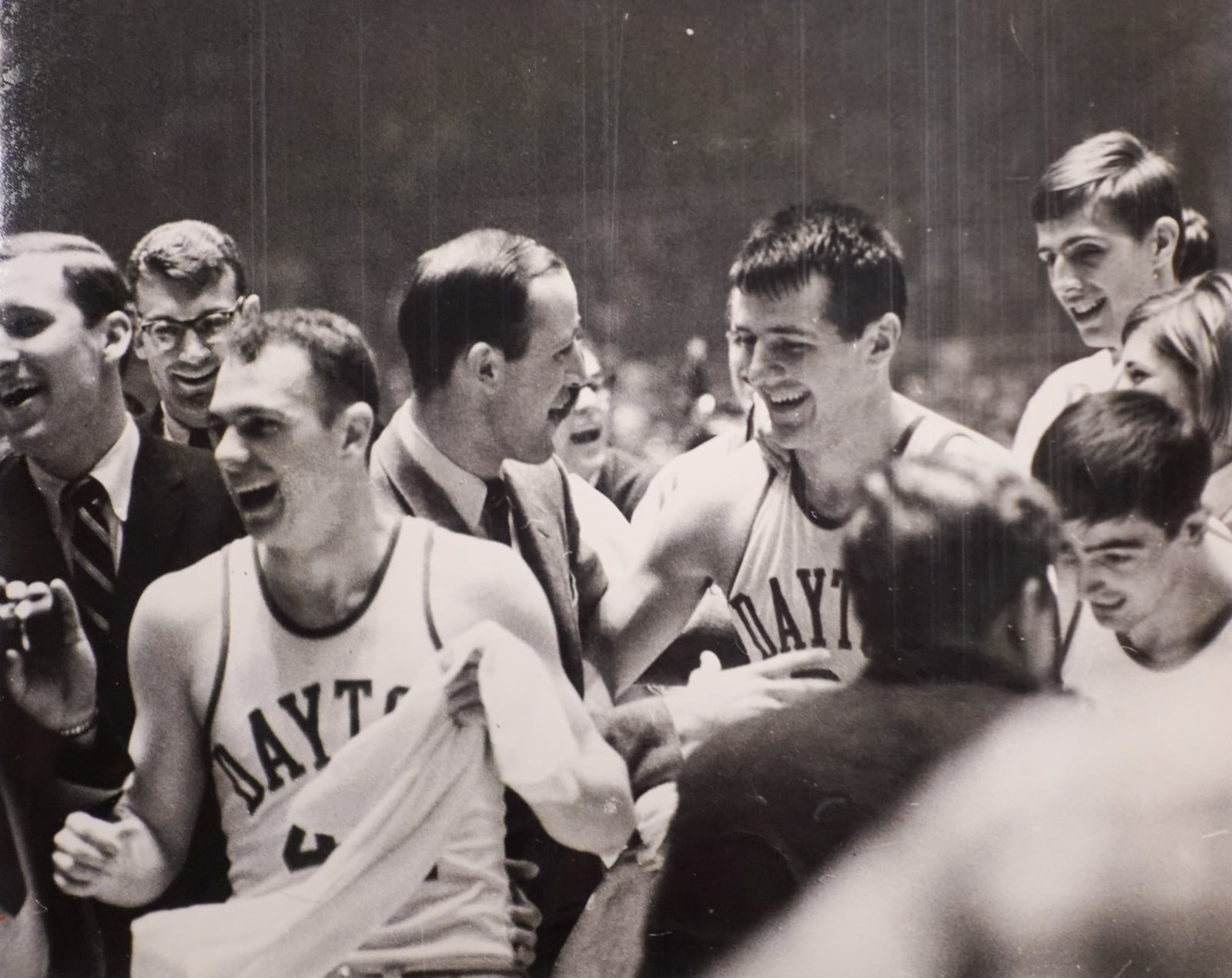 Dayton Flyers basketball. Guard Bob Hooper, coach Don Donoher, Don May and Dan Obrovac after game against North Carolina. Mar. 25, 1967. COURTESY OF WRIGHT STATE UNIVERSITY, DAYTON DAILY NEWS ARCHIVE