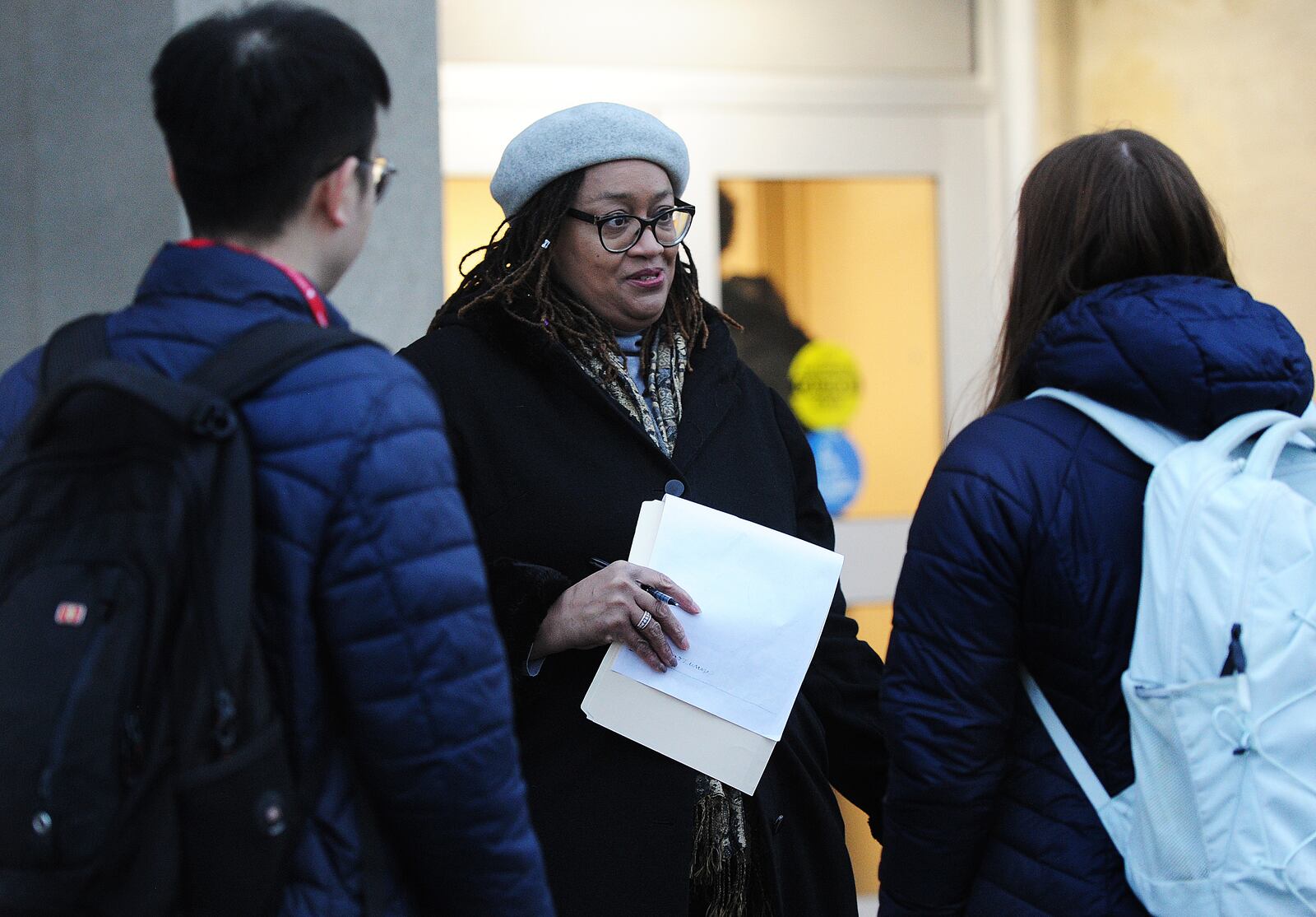 University of Dayton professor Rochonda Nenonene, talks with students getting ready to board buses to go student teach at local schools Tuesday Feb. 7, 2023. MARSHALL GORBY\STAFF