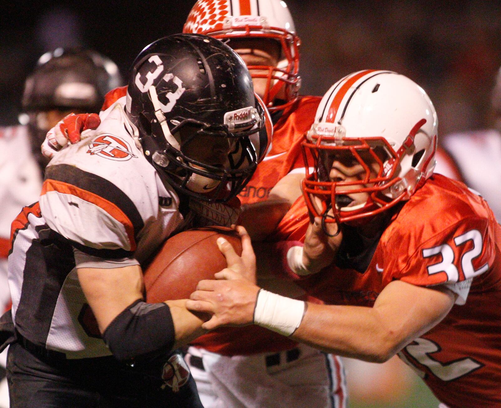 Chuck Buchanan (33) of Tecumseh is tackled by Austin Clack (32) of Tippecanoe during Friday's football game in Tipp City on October 12, 2012. Barbara J. Perenic/Springfield News-Sun