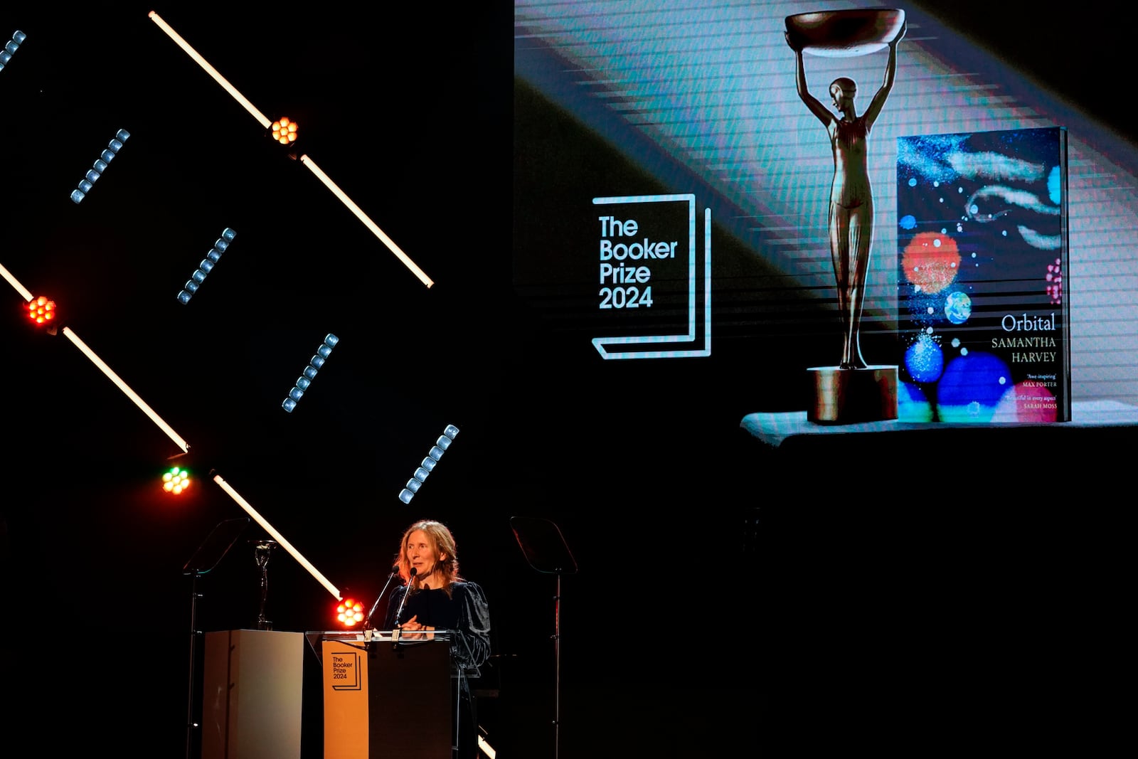 Samantha Harvey speaks on stage after winning the Booker Prize award 2024, in London, Tuesday, Nov. 12, 2024. (AP Photo/Alberto Pezzali)