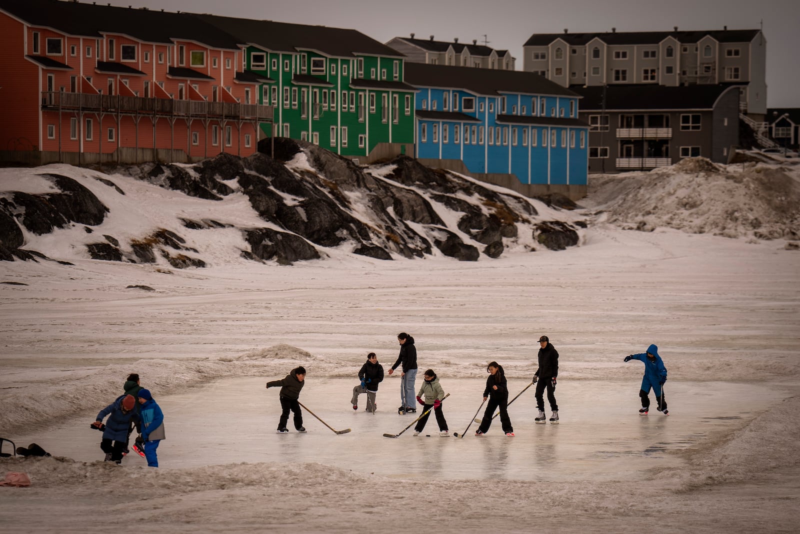 FILE - Children play on an icy surface in Nuuk, Greenland, Feb. 16, 2025. (AP Photo/Emilio Morenatti, File)