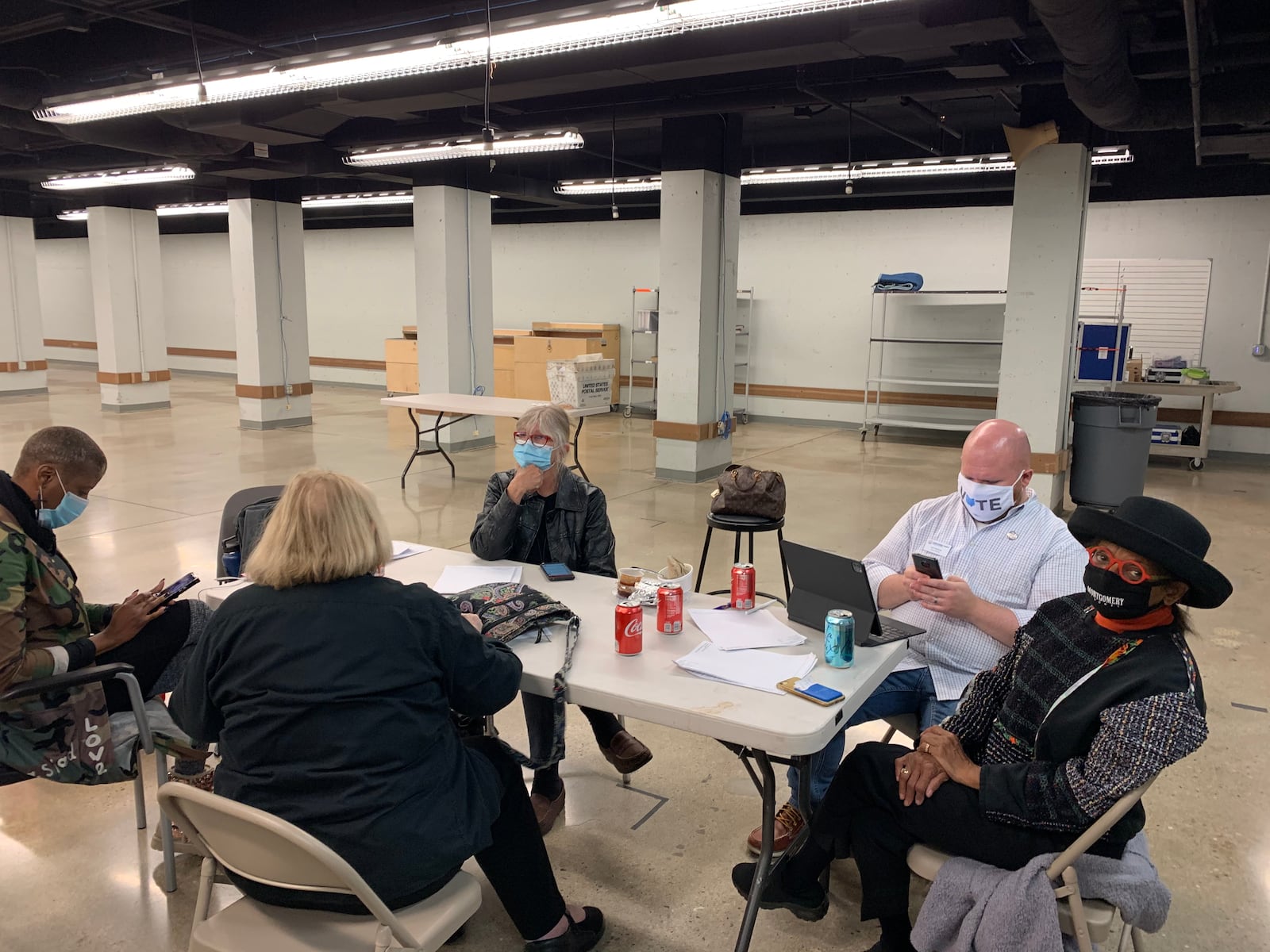 The two Democratic and two Republican members of the Montgomery County Board of Elections wait nearby as votes are counted.