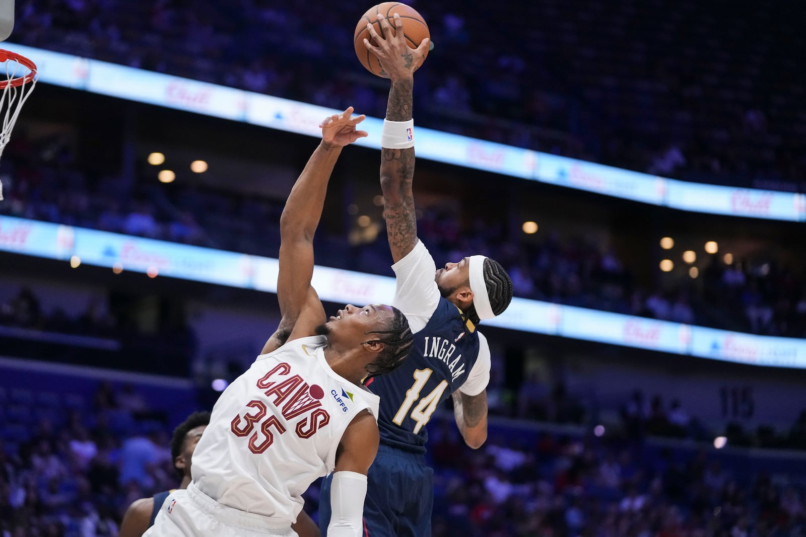 New Orleans Pelicans forward Brandon Ingram (14) leaps for a rebound over Cleveland Cavaliers forward Isaac Okoro (35) in the first half of an NBA basketball game in New Orleans, Wednesday, Nov. 6, 2024. (AP Photo/Gerald Herbert)