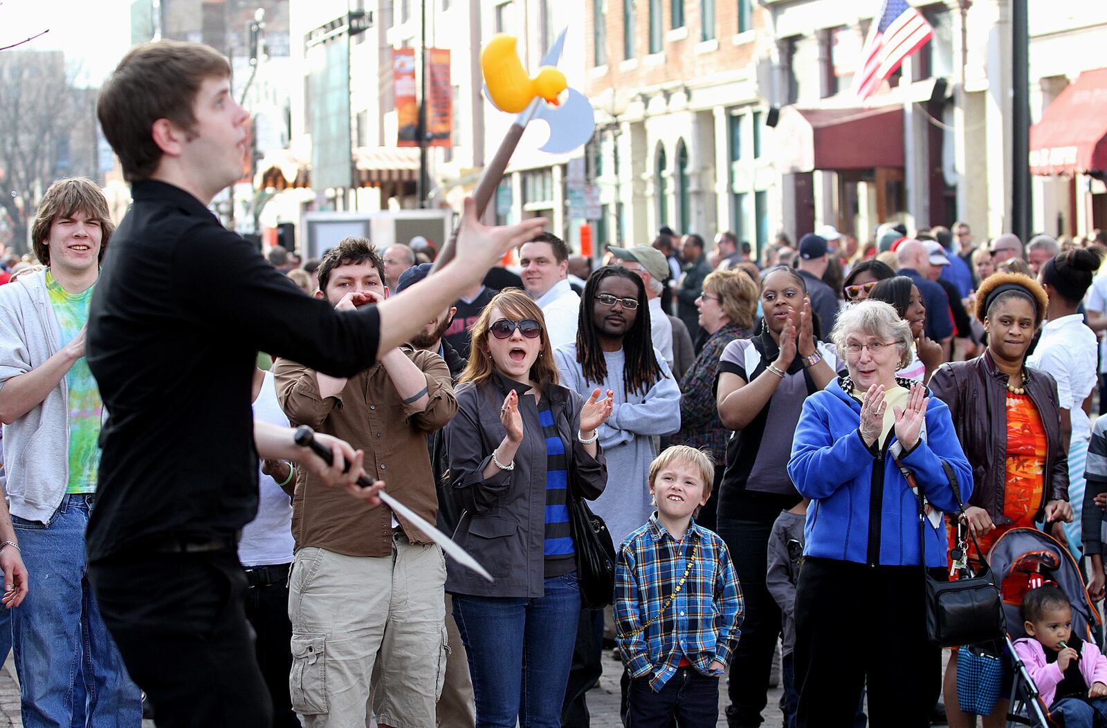 E.L. Hubbard photography People watch a street performer during the NCAA First Four Festival in downtown Dayton's Oregon District Sunday, March 11, 2012.