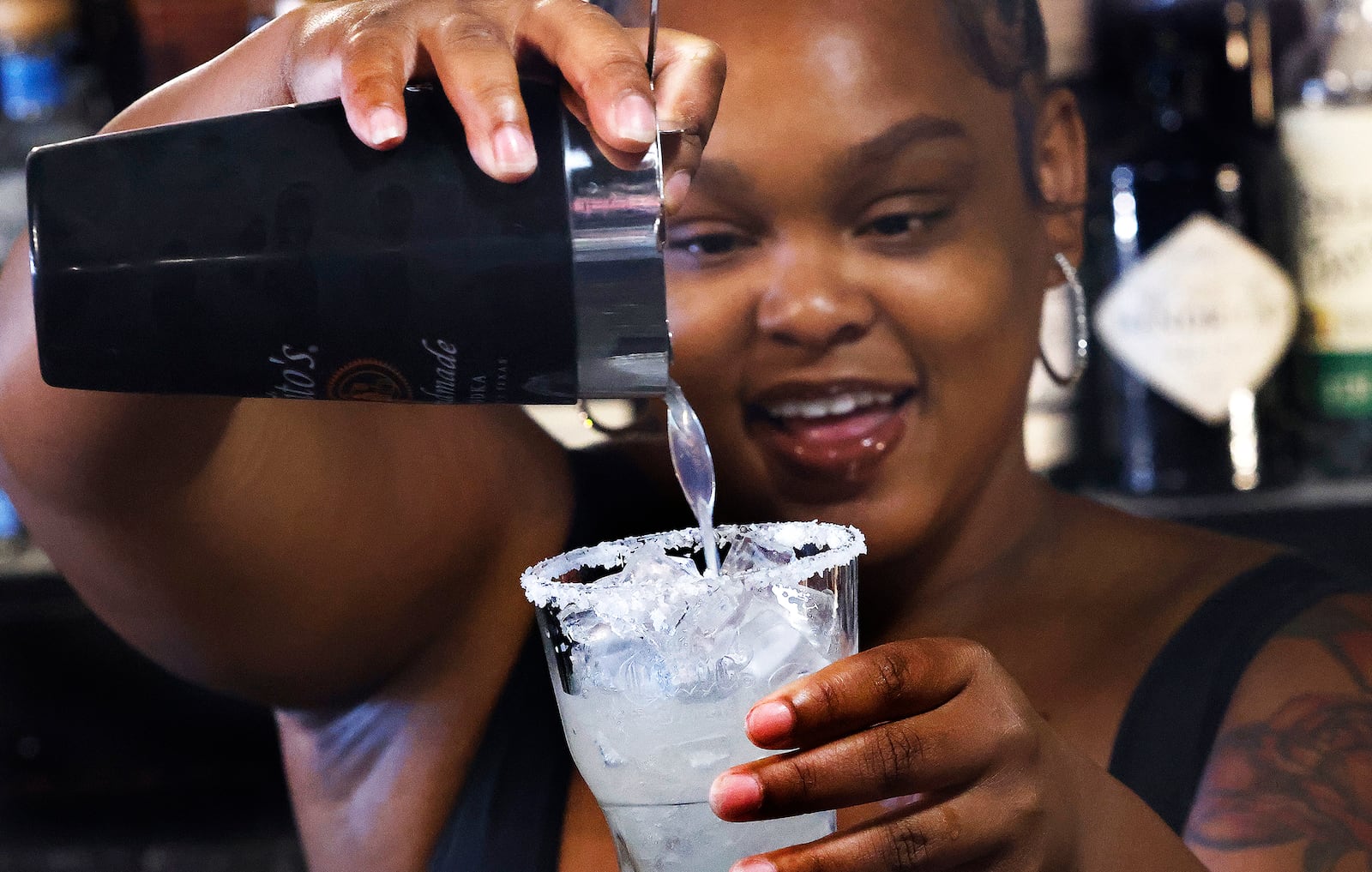 Bartender Angel Comer makes a drink at The Reserve on Third in Dayton. The lounge won Best Happy Hour and Best Karaoke in the 2024 Best of Dayton contest. MARSHALL GORBY\STAFF