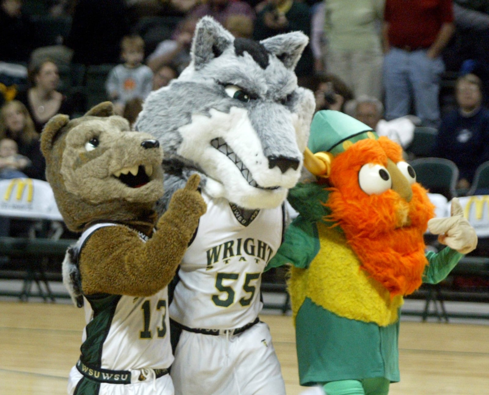 1/10/07 -- ddn011107wsubbp -- Retiring Rowdy Raider (left) and an earlier Wright State mascot (right) embrace the latest mascot (center) during halftime of the WSU game with Loyola at the Nutter Center.  The new mascot was introduced during a halftime celebration. PHOTO BY JAN UNDERWOOD