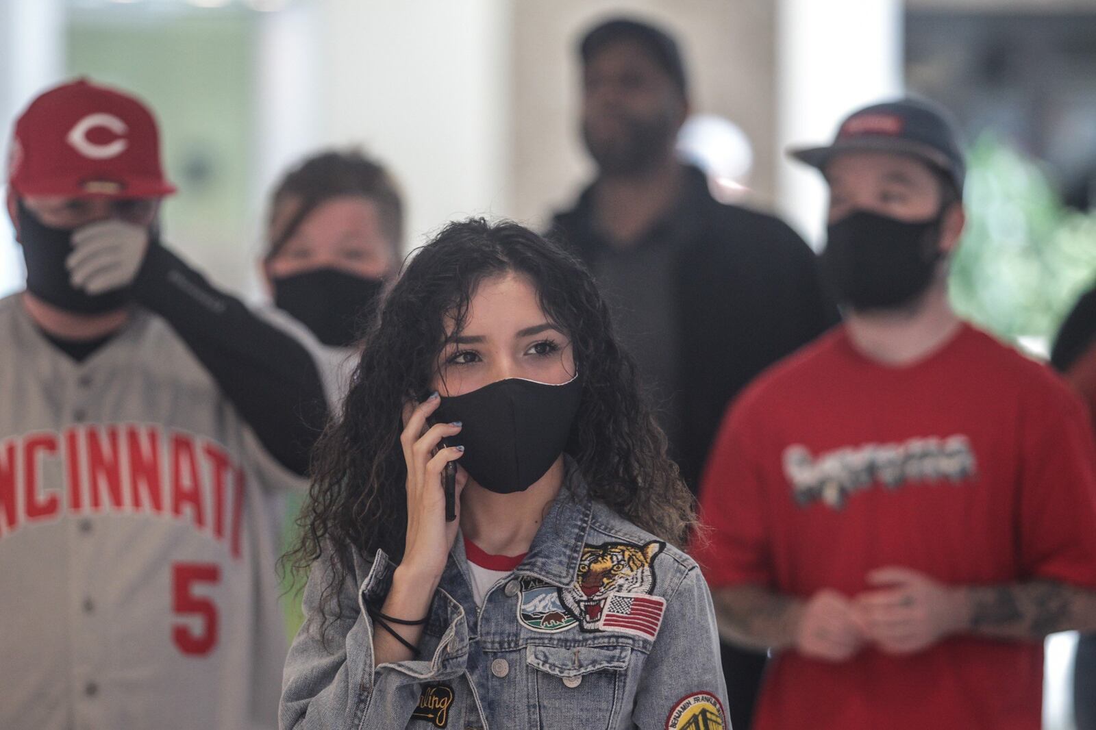 Diana Sanchez waits in line to buy shoes for her boy friend Tuesday morning at the Dayton Mall. The open opened at 11am for the first time in six weeks. JIM NOELKER/STAFF