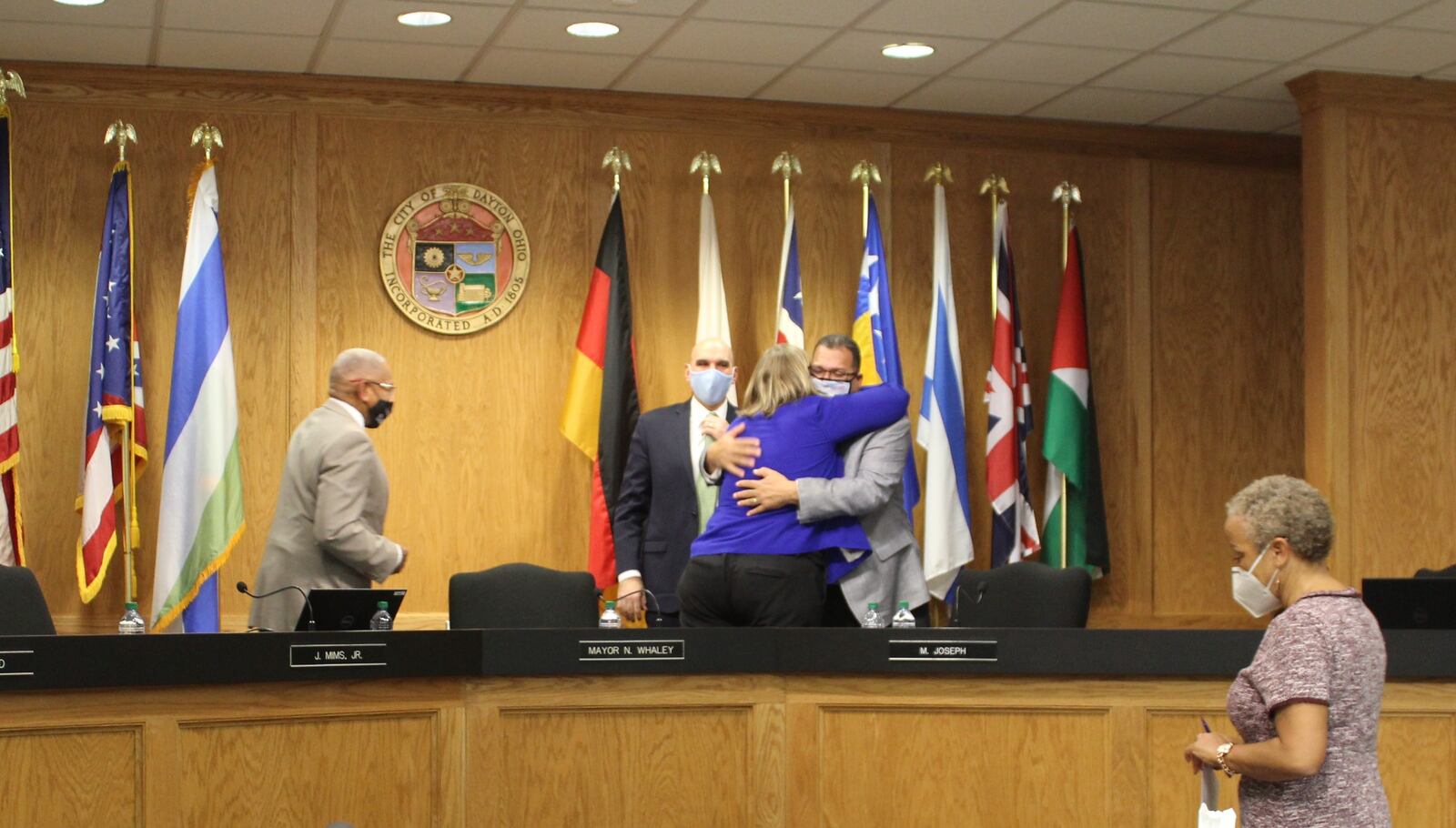 Dayton Mayor Nan Whaley gives Commissioner Chris Shaw a hug after Wednesday's city commission meeting, which will be Whaley's last in office. CORNELIUS FROLIK / STAFF