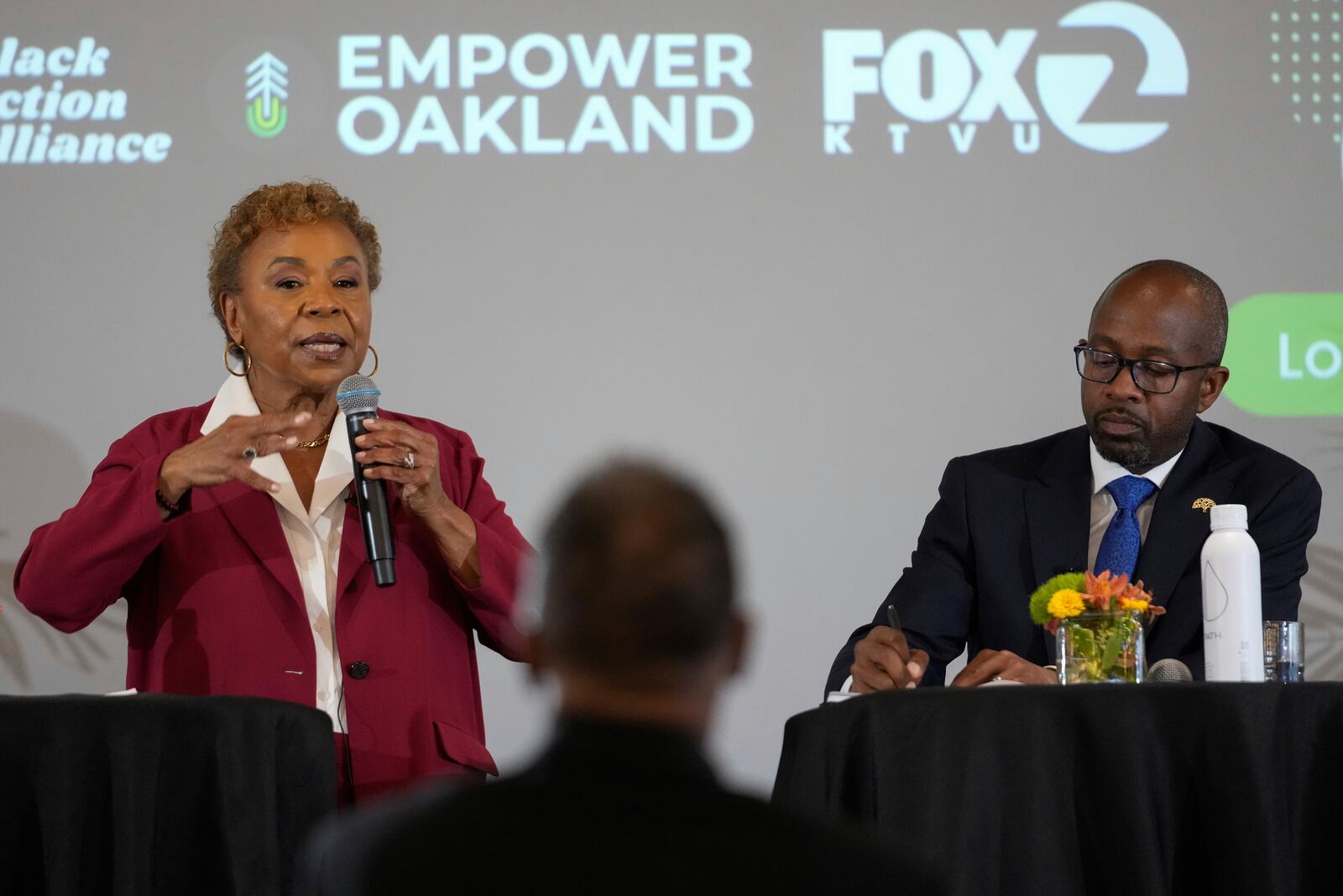 Barbara Lee, left, answers a question next to fellow Oakland mayoral candidate Loren Taylor during a debate Tuesday, March 11, 2025, in Oakland, Calif. (AP Photo/Godofredo A. Vásquez)