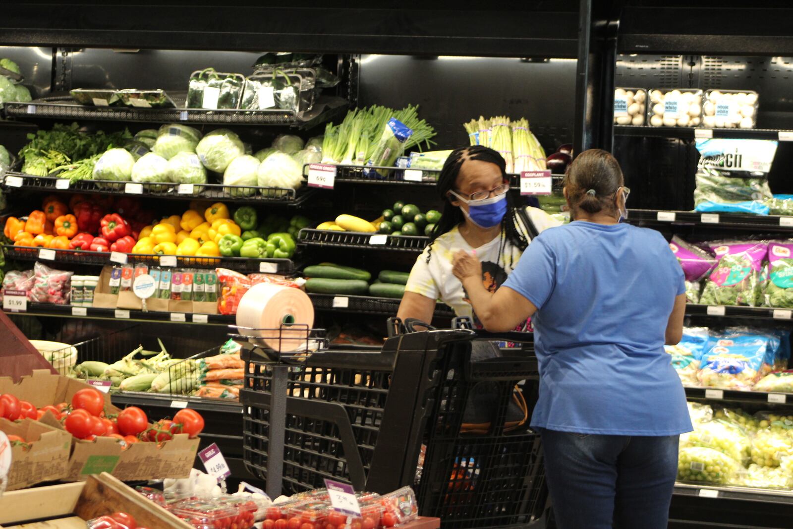 Shoppers in the produce aisle at the Gem City Market on Wednesday. CORNELIUS FROLIK / STAFF