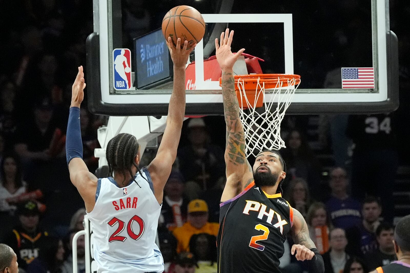 Washington Wizards forward Alex Sarr (20) tries to shoot over Phoenix Suns center Nick Richards (2) during the second half of an NBA basketball game Saturday, Jan. 25, 2025, in Phoenix. (AP Photo/Ross D. Franklin)