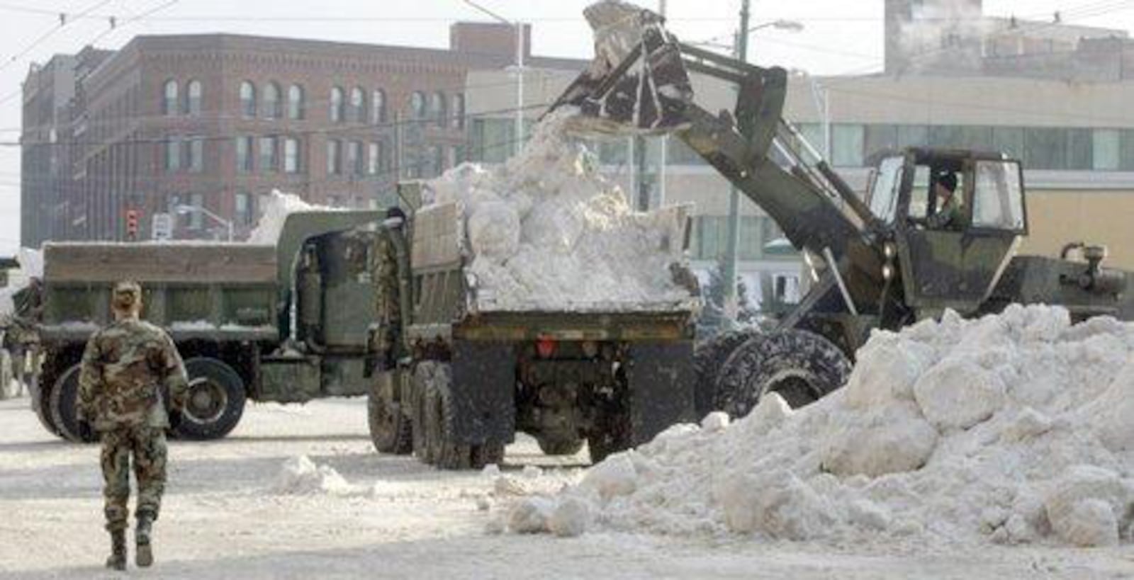 The Ohio National Guard removes snow from Dayton streets in the aftermath of the 2004 winter storm. DAYTON DAILY NEWS ARCHIVE