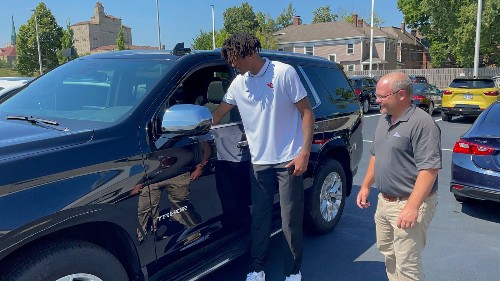 DaRon Holmes II looks over a Chevy Tahoe with Tim White Jr., President of of White-Allen, on Friday, July 15, 2022, in Dayton. Photo courtesy of Matt Farrell