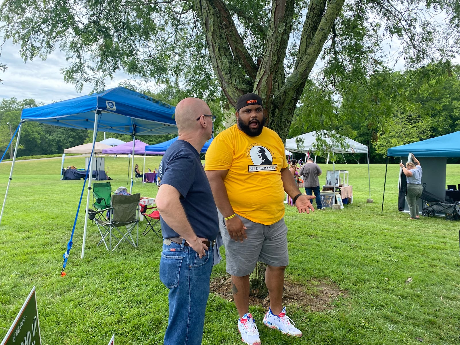 Wade Crise, left, speaks with Ben Wotawa, right, at the Springboro Juneteenth Jubilee on Saturday at North Park. Eileen McClory / Staff