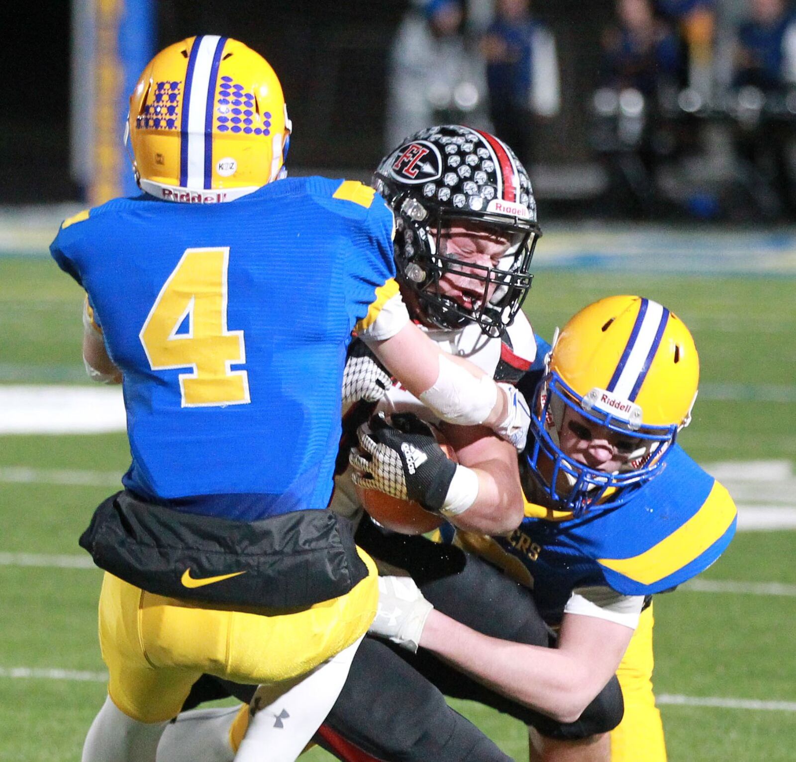 Nick Brandewie (with ball) of Fort Loramie is taken down by Peyton Otte (4) and Trent Pleiman of Marion Local. Marion Local defeated Fort Loramie 24-21 in OT in a Division VII, Region 28 high school football regional semifinal at St. Marys Memorial on Saturday, Nov. 16, 2019. MARC PENDLETON / STAFF