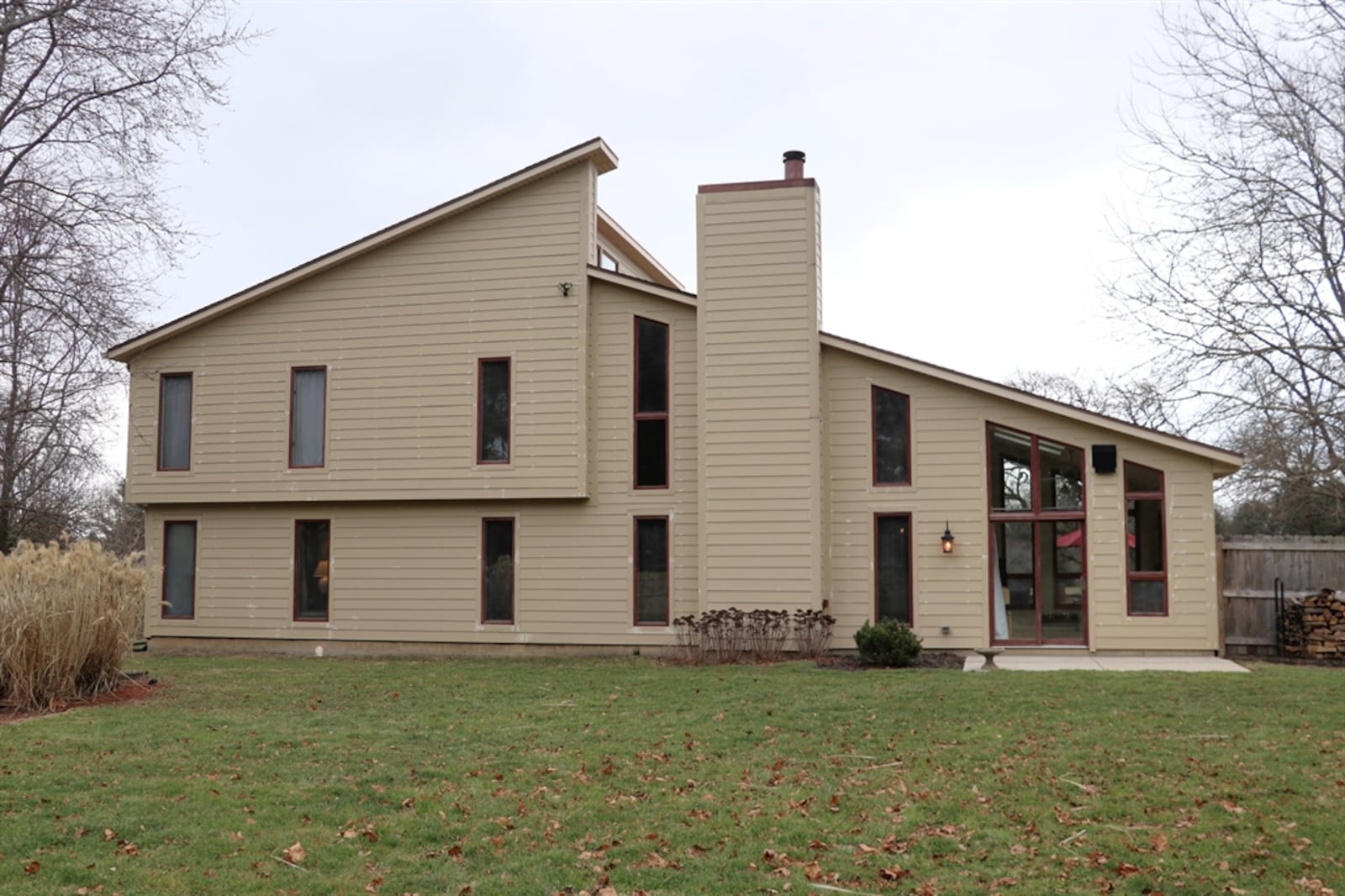 The 1.065-acre property has a wooden privacy fence that surrounds the backyard, which has a storage barn and concrete patio.