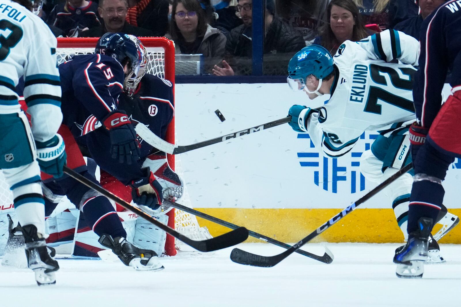 San Jose Sharks left wing William Eklund (72) shoots on Columbus Blue Jackets goaltender Elvis Merzlikins next to defenseman Dante Fabbro (15) in the second period of an NHL hockey game Thursday, Jan. 16, 2025, in Columbus, Ohio. (AP Photo/Sue Ogrocki)