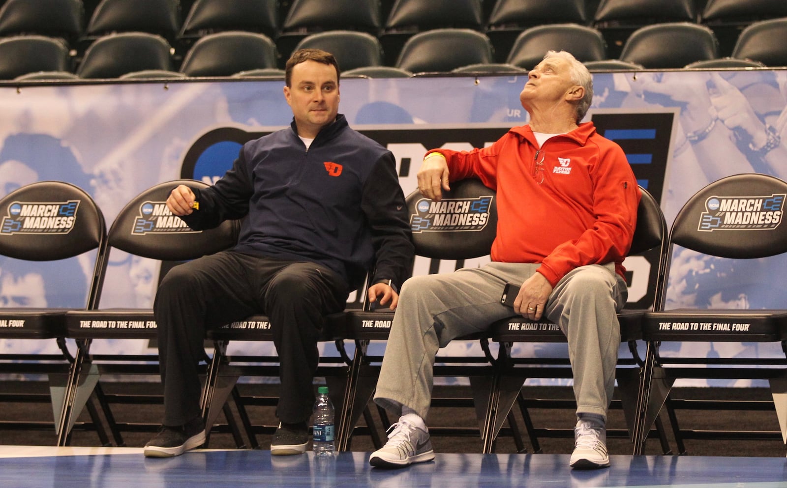 Archie Miller and John Miller sit together as Dayton practices March 16, 2017, at Bankers Life Fieldhouse in Indianapolis. David Jablonski/Staff