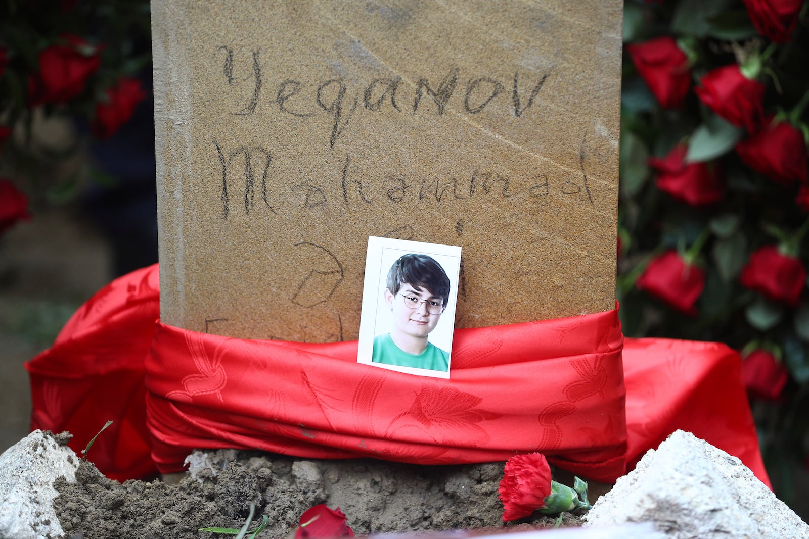 The tomb of Mahammadali Eganov, 13 who died in the Azerbaijan Airlines Embraer 190 crash near Kazakhstan's Aktau airport, in Baku, Azerbaijan, Saturday, Dec. 28, 2024. (AP Photo)