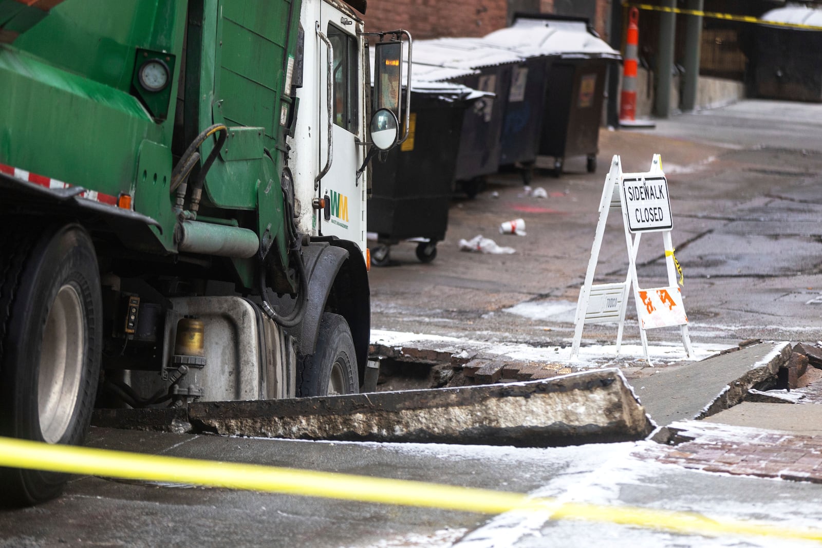 A garbage truck is stuck in a sinkhole in downtown Omaha, Neb., Thursday, Jan. 2, 2025. (Chris Machian/Omaha World-Herald via AP)