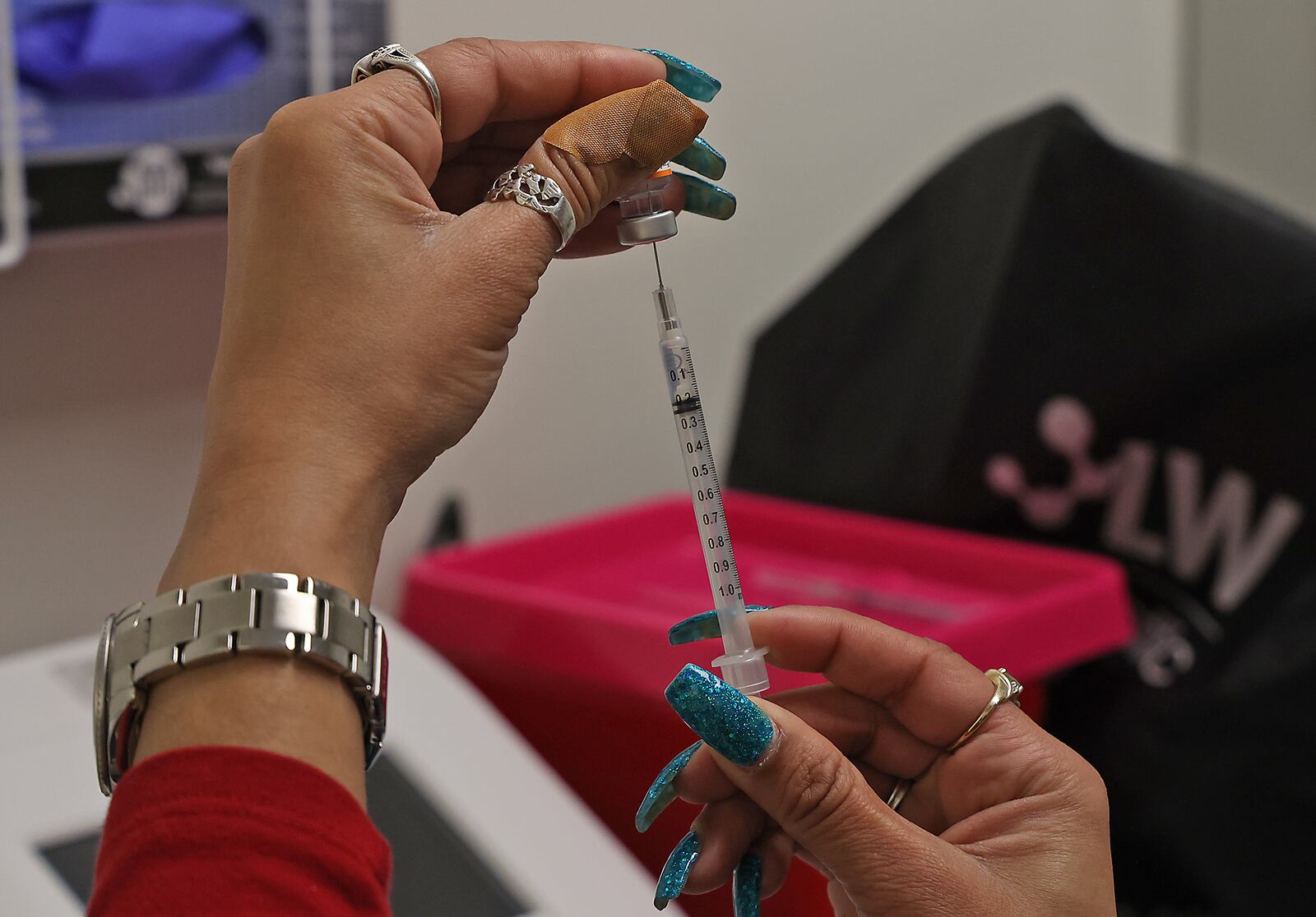 Senika Channels gets a patient's COVID vaccine ready Friday, Feb. 25, 2022 at the Clark County Combined Health District office in the Southern Village Shopping Center. BILL LACKEY/STAFF