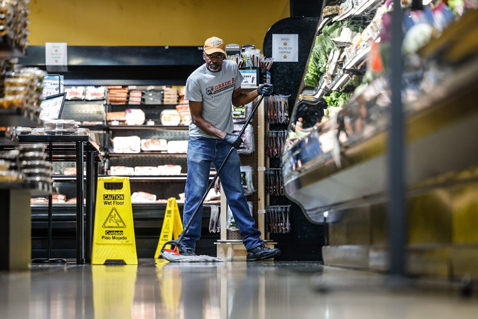 Sam Stockton, facilities manager for Gem City Market, mops the floor of the market Thursday morning September 21, 2023. The market had a tough start but is making progress. JIM NOELKER/STAFF