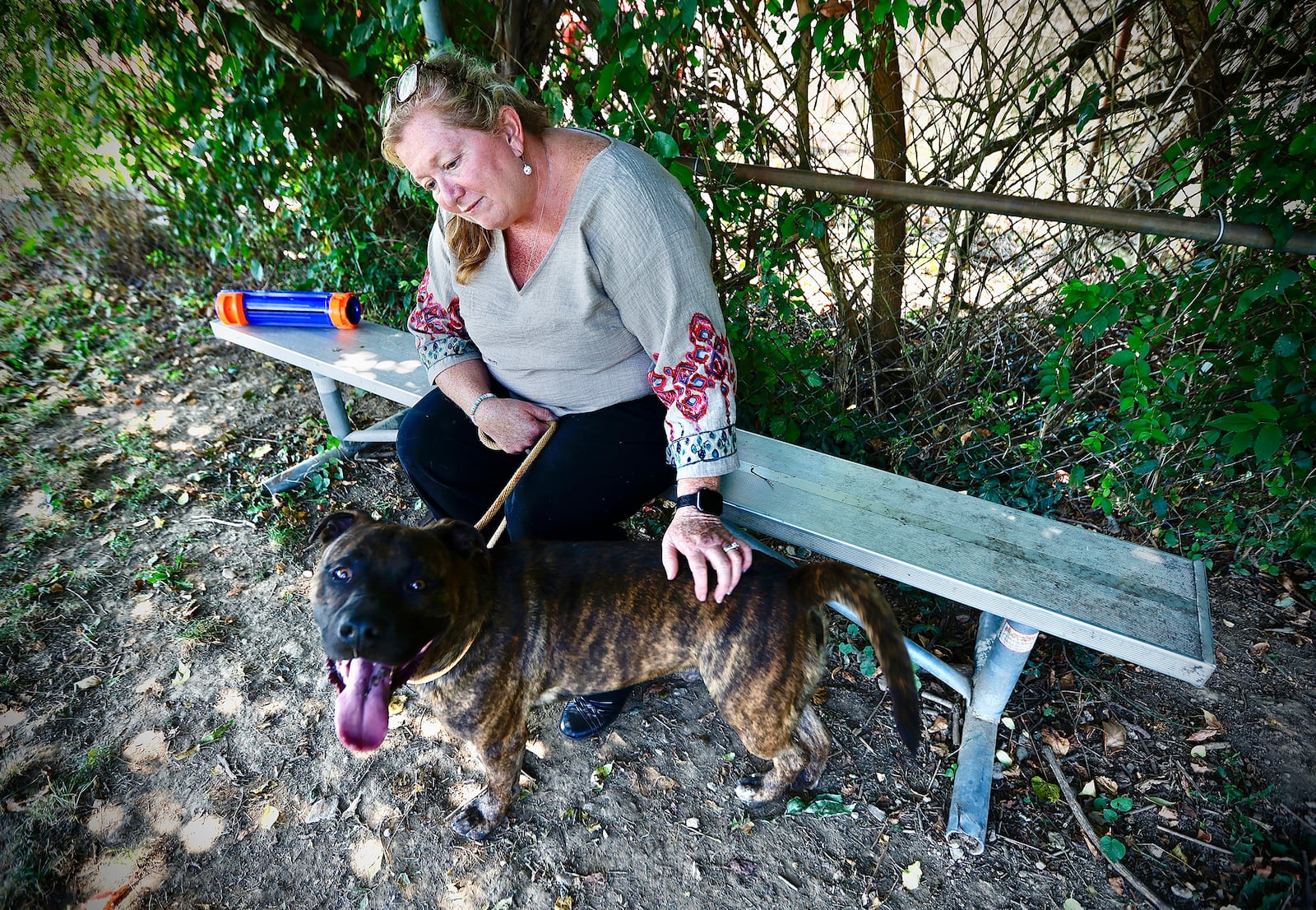 Julie Holmes-Taylor, Director of the Greene County Animal Control, spends time outside with Jaeger, Wednesday, Aug. 28, 2024. Jaeger is one of several dogs up for adoption at the shelter. MARSHALL GORBY\STAFF