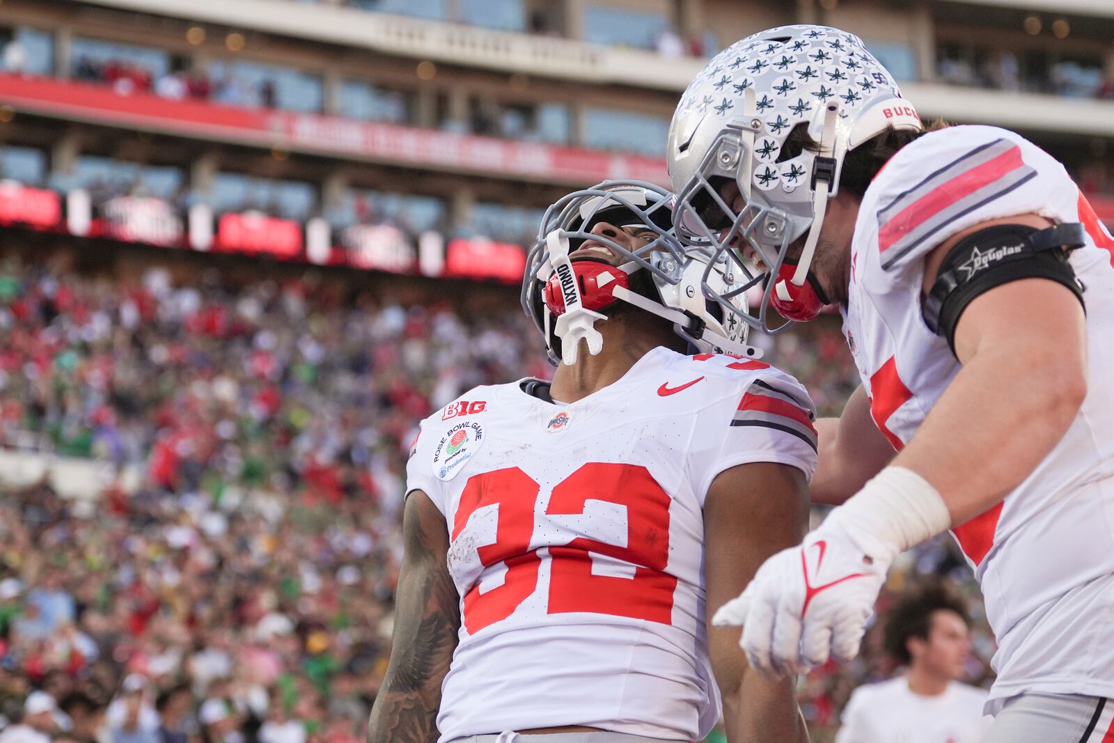 Ohio State running back TreVeyon Henderson (32) celebrates his touchdown with tight end Bennett Christian (85) during the first half in the quarterfinals of the Rose Bowl College Football Playoff against Oregon, Wednesday, Jan. 1, 2025, in Pasadena, Calif. (AP Photo/Mark J. Terrill)