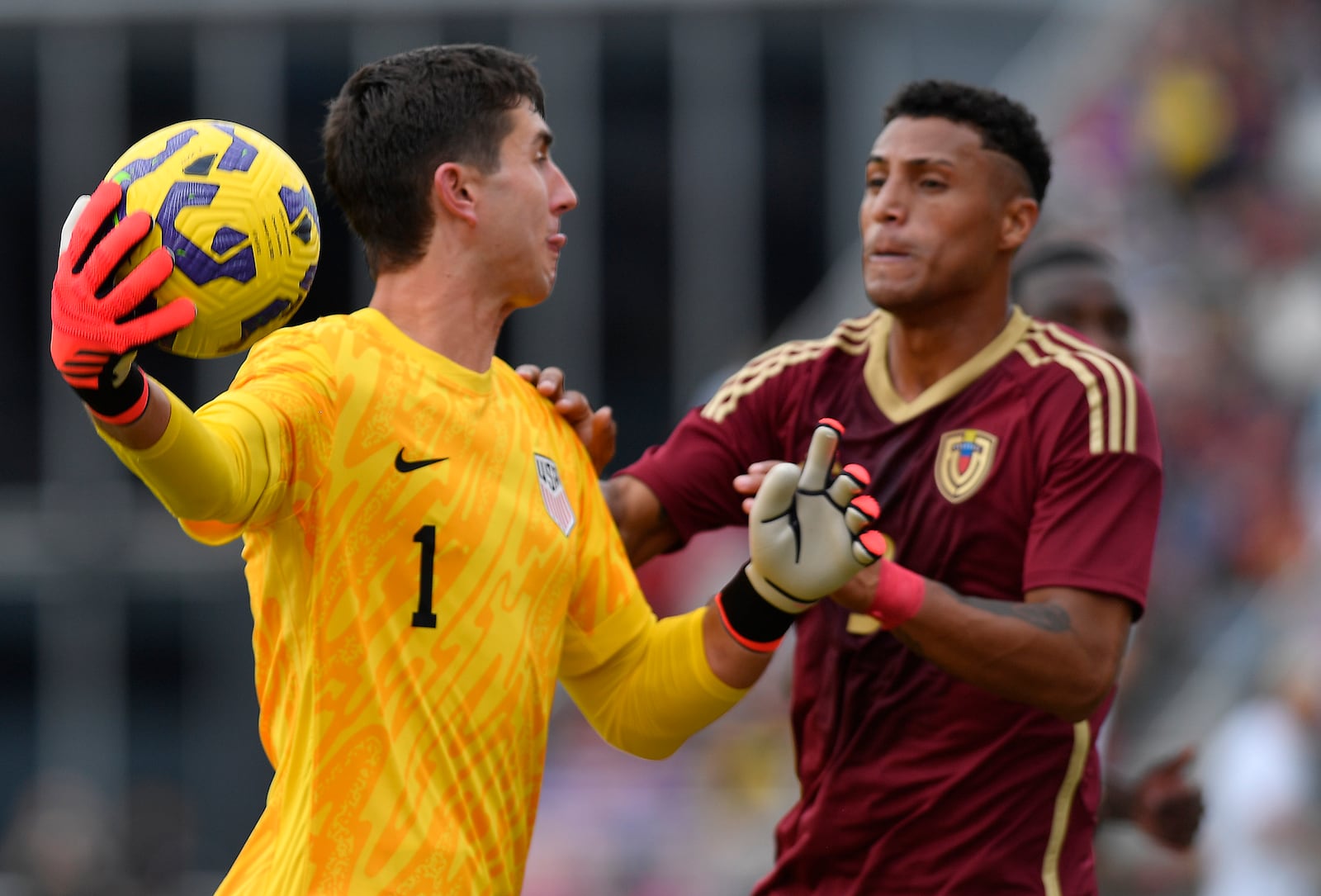 United States goalkeeper Patrick Schulte (1) throws the ball around Venezuela defender Anthony Graterol (3) during the first half of an international friendly soccer game, Saturday, Jan 18, 2025, in Fort Lauderdale, Fla. (AP Photo/Michael Laughlin)