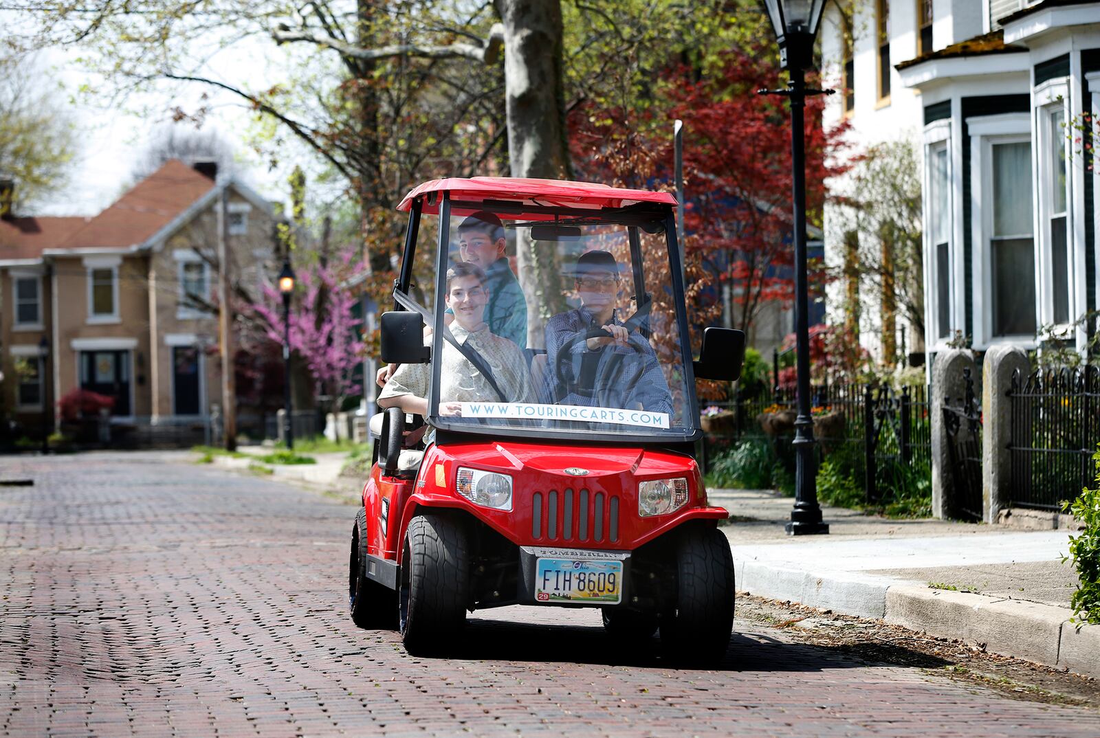 John Meixner of Bellbrook and his sons Aaron, 15, and Alex, 14, have started Touring Carts, a new business that will provide golf cart tours of Dayton. Meixner said he wanted his children to experience what it takes to start a business. The historic tours will visit many areas of the city including the historic Oregon District.  LISA POWELL / STAFF