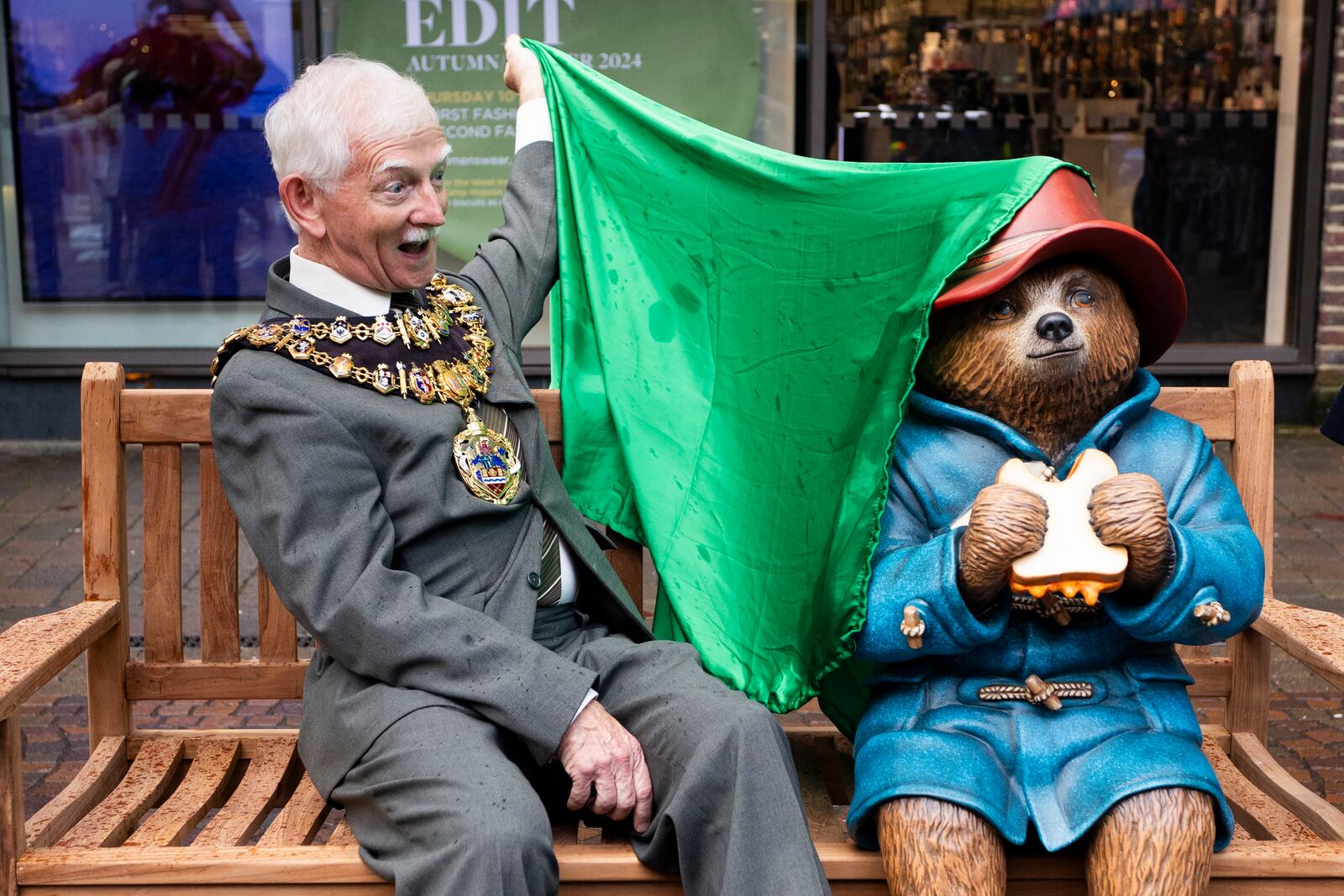 This photo made available by PinPep shows Mayor of Newbury Andy Moore unveiling a statue of Paddington Bear in Newbury, England, Oct. 8, 2024. (Tom Wren/PinPep via AP)