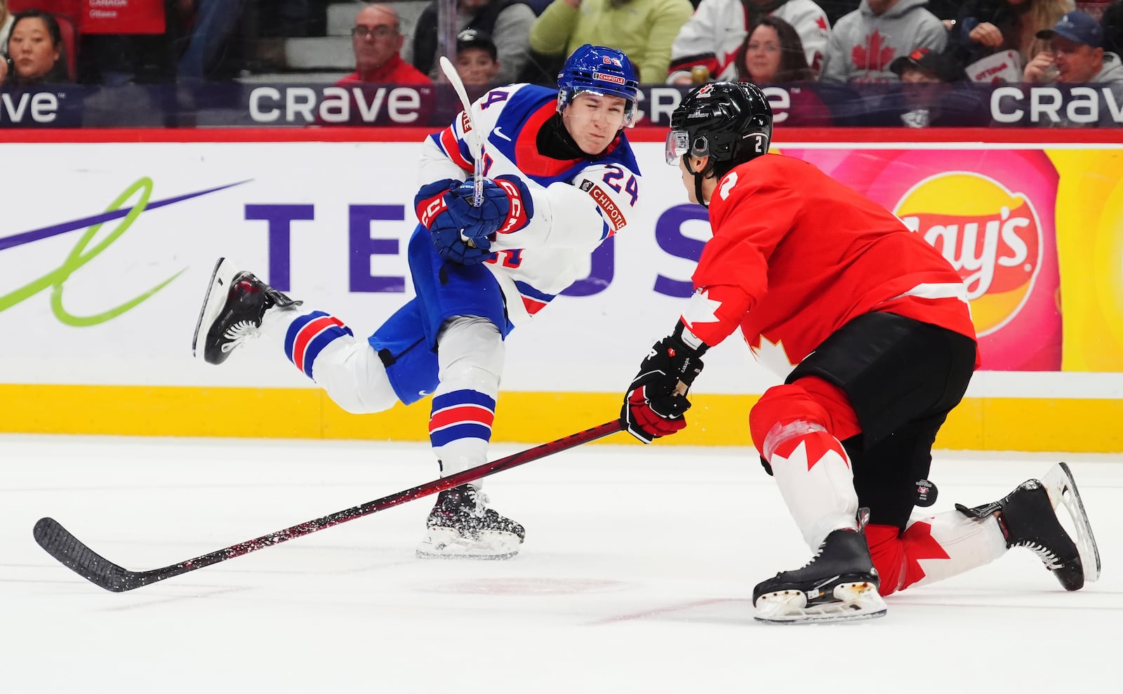 Canada's Andrew Gibson (2) blocks a shot from United States' Cole Hutson (24) during the first period of an IIHF World Junior Hockey Championship tournament game in Ottawa, Ontario on Tuesday, Dec. 31, 2024. (Sean Kilpatrick/The Canadian Press via AP)