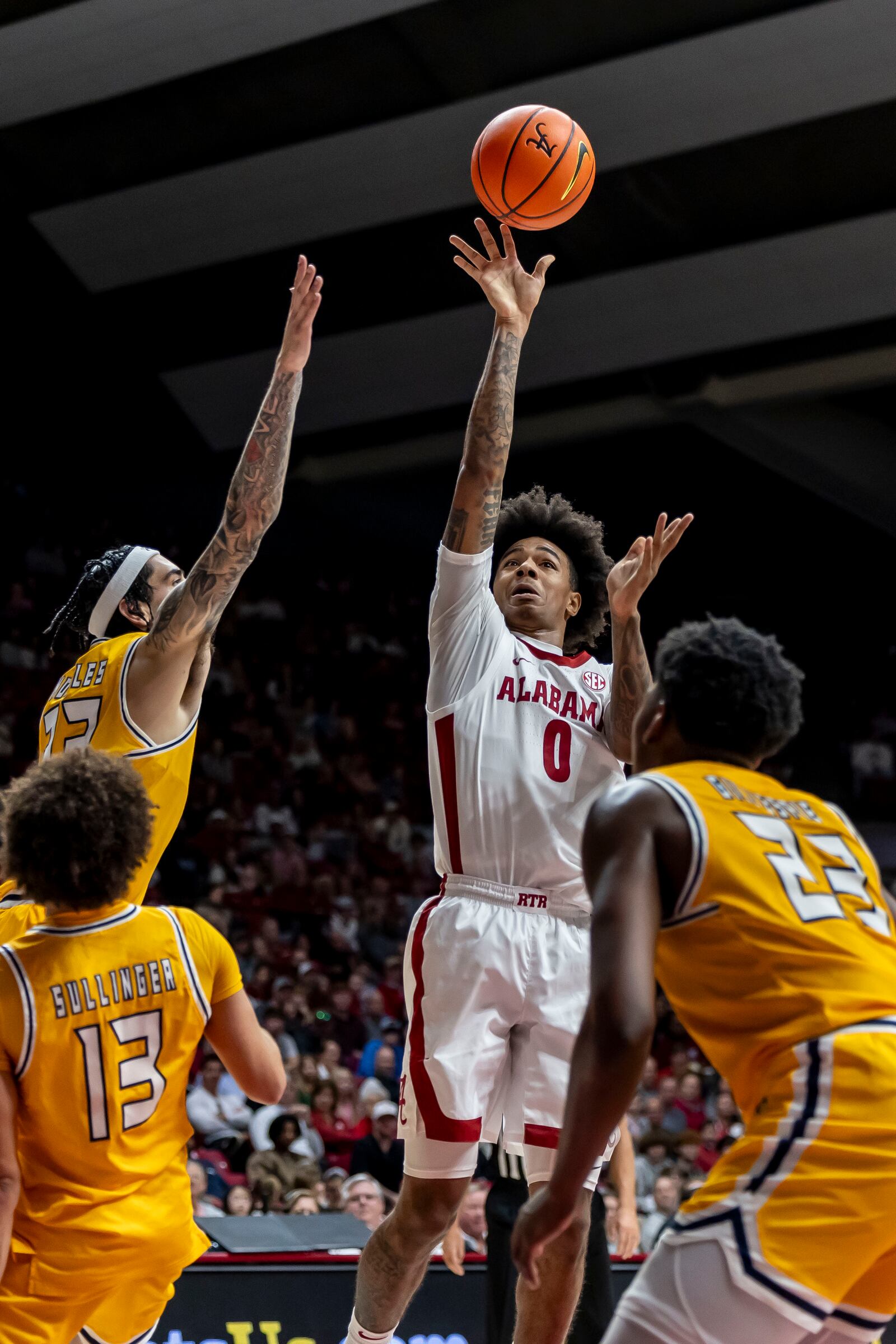 Alabama guard Labaron Philon (0) shoots with Kent State forward Anthony Morales (22) defending during the first half of an NCAA college basketball game, Sunday, Dec. 22, 2024, in Tuscaloosa, Ala. (AP Photo/Vasha Hunt)