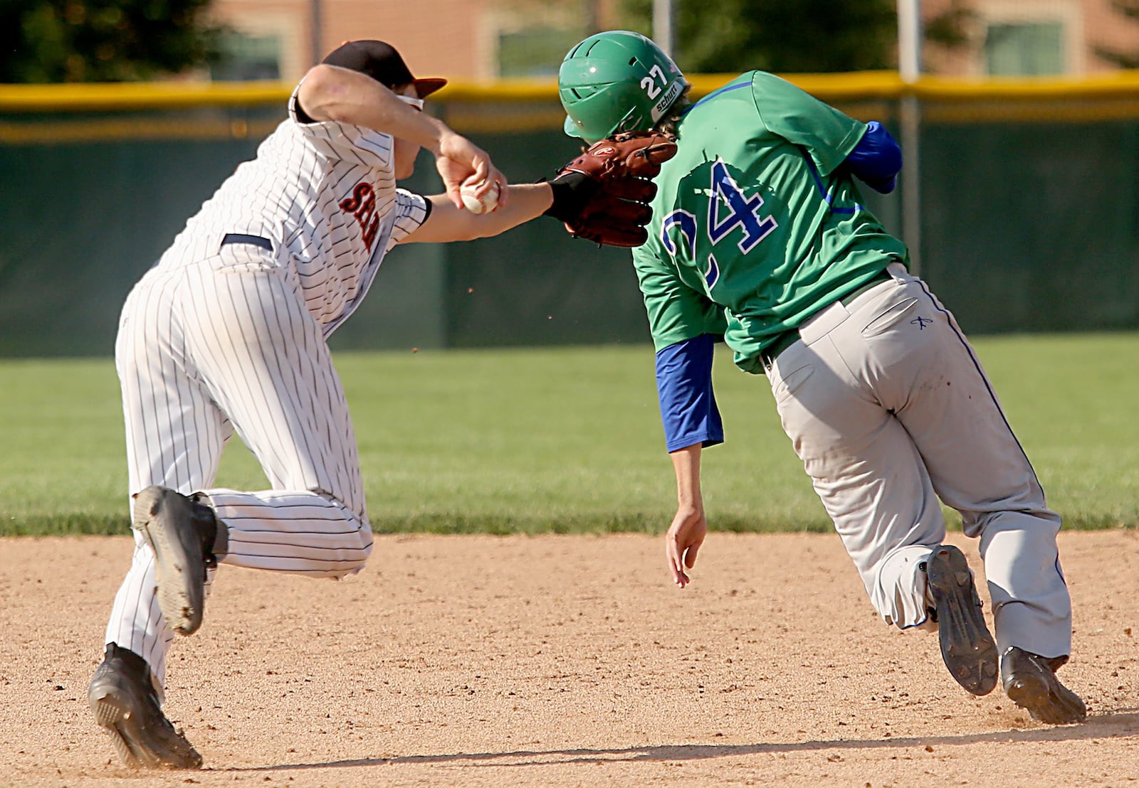 Waynesville shortstop Kyle Leis fails to tag Chaminade Julienne’s Joey Greene, but Greene is called out for leaving the baseline, during Friday’s Division II regional semifinal at Mason. CONTRIBUTED PHOTO BY E.L. HUBBARD