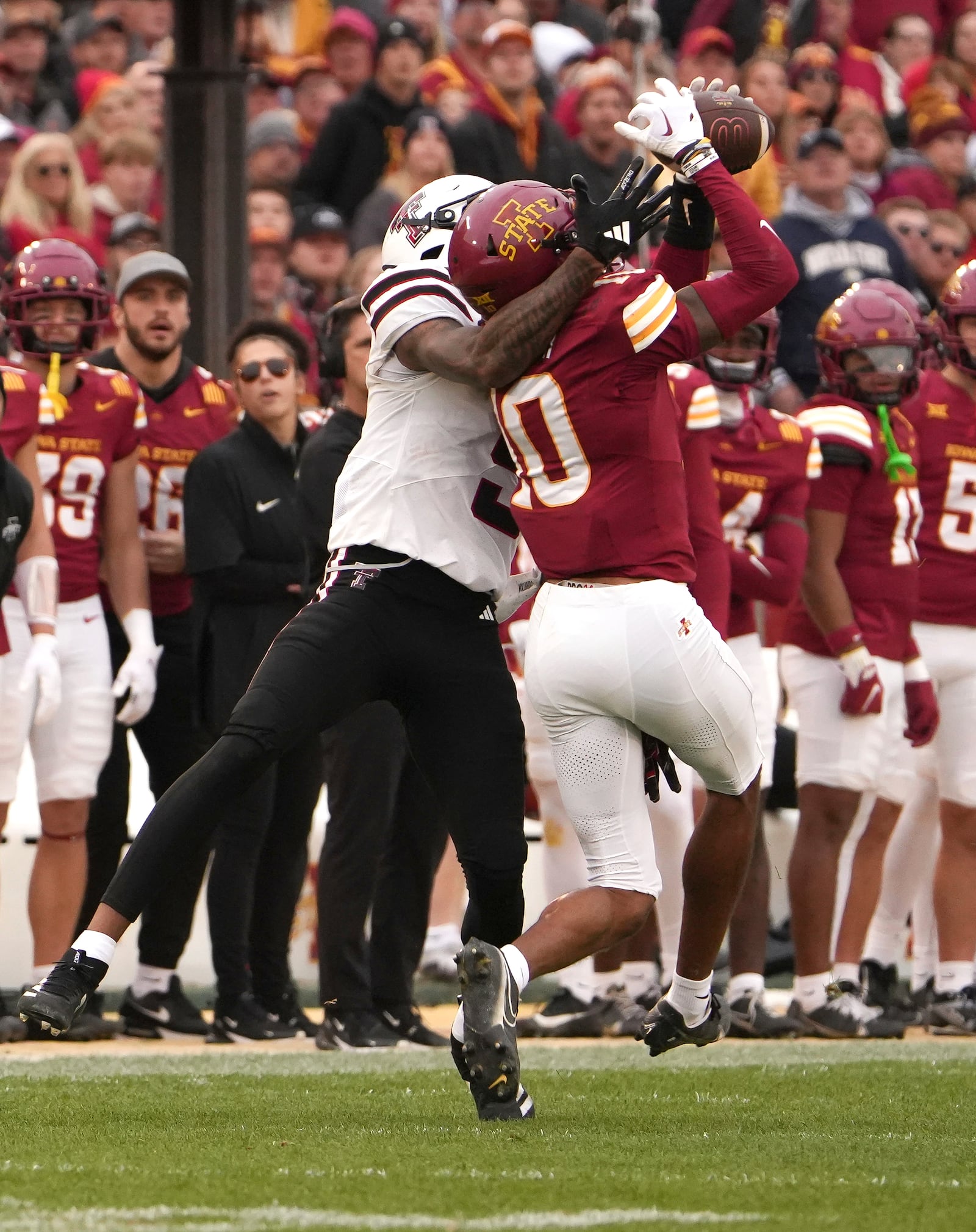 Iowa State defensive back Darien Porter (10) intercepts the ball against Texas Tech wide receiver Caleb Douglas, left, during the first half of an NCAA college football game, Saturday, Nov. 2, 2024, in Ames, Iowa. (AP Photo/Bryon Houlgrave)