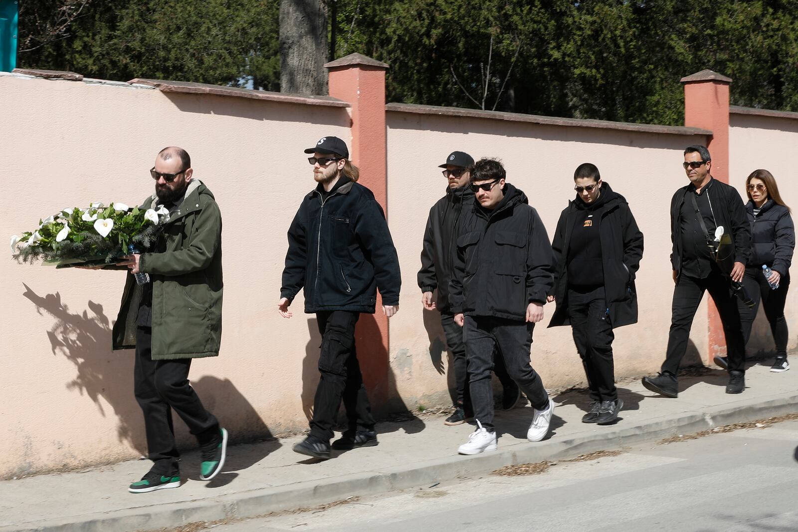 People arrive at the chapel for the funeral of Andrej Gjorgieski, one of the lead singers of Macedonian band DNK, a victim of the March 16 nightclub fire in the town of Kocani, at a cemetery in Skopje, North Macedonia, Thursday, March 20, 2025. (AP Photo/Boris Grdanoski)